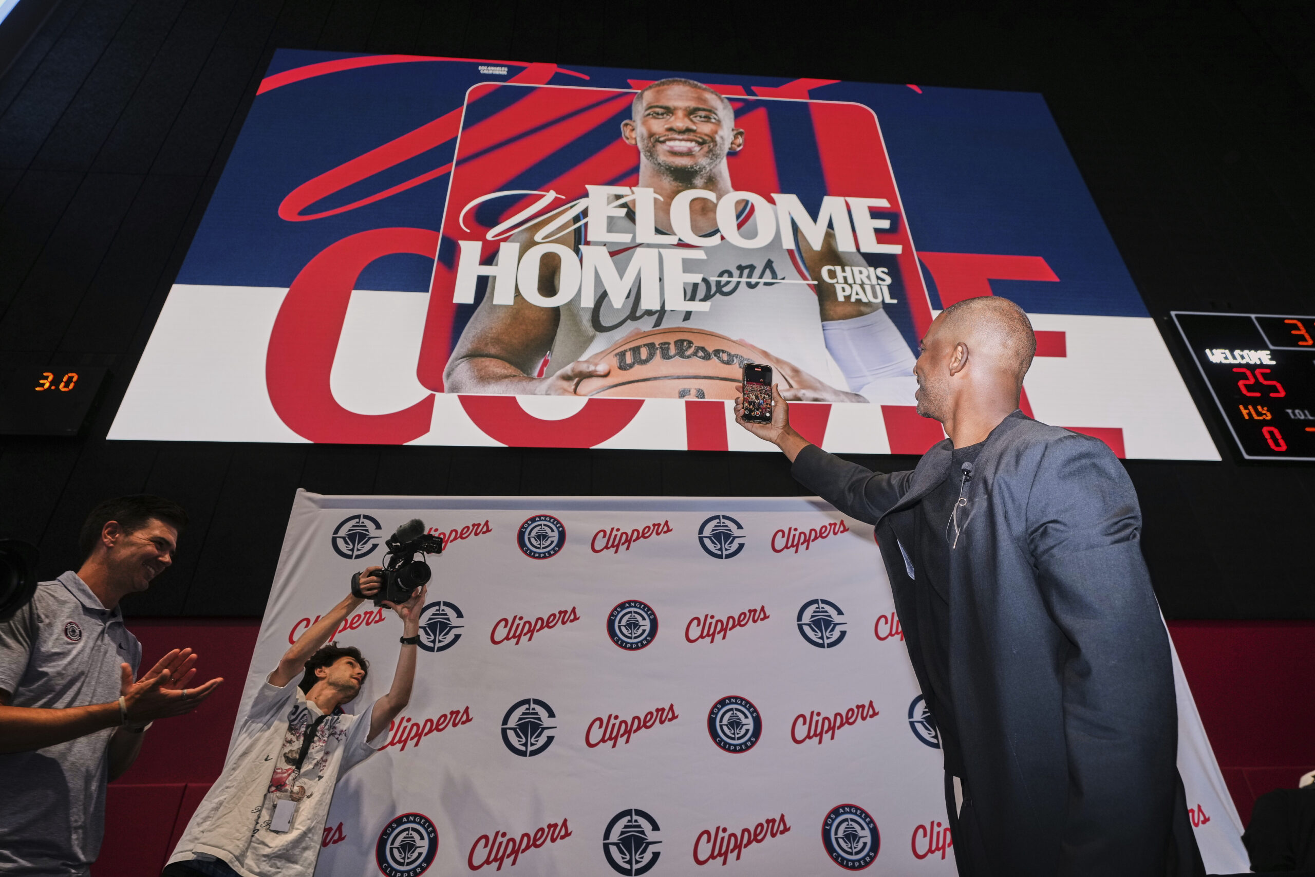 Clippers guard Chris Paul, right, takes a selfie after a...
