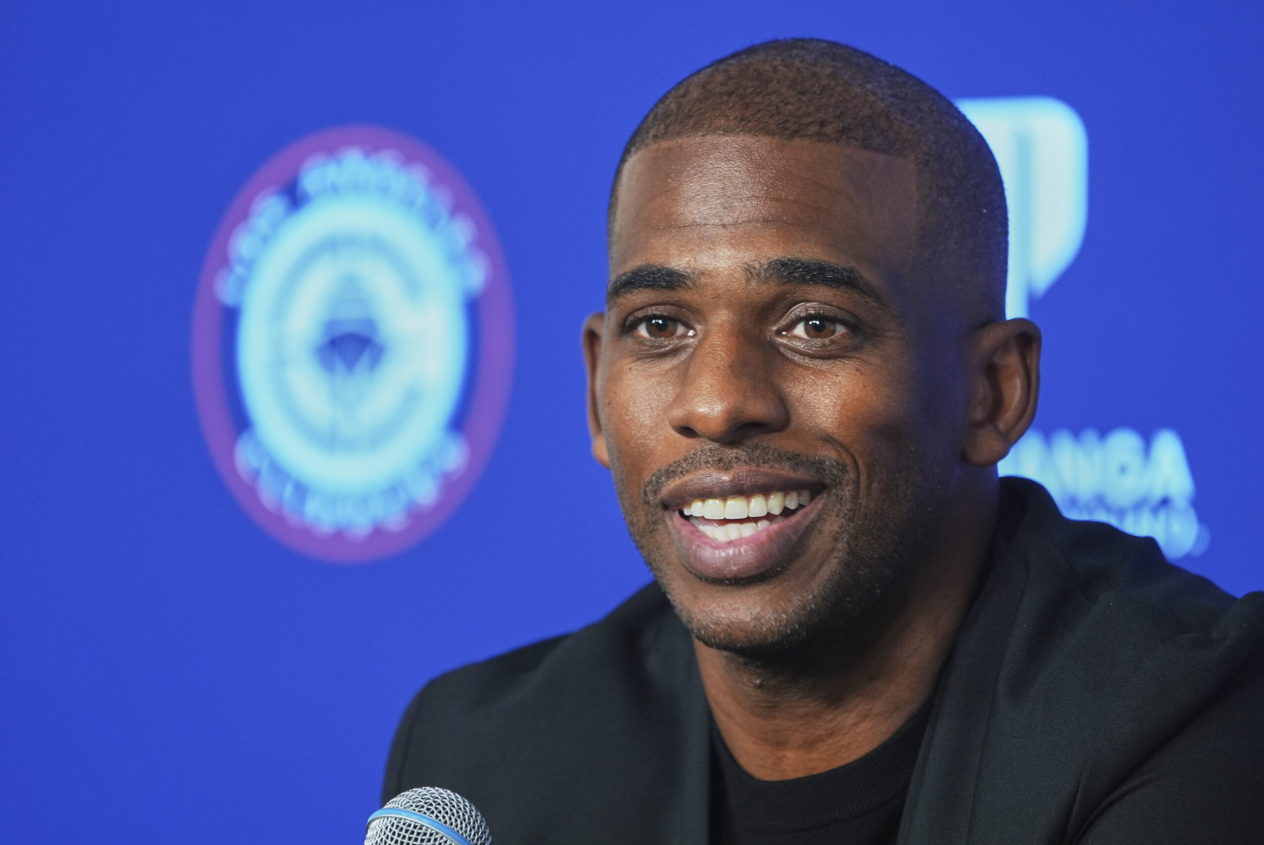 Clippers guard Chris Paul takes questions from reporters during a...