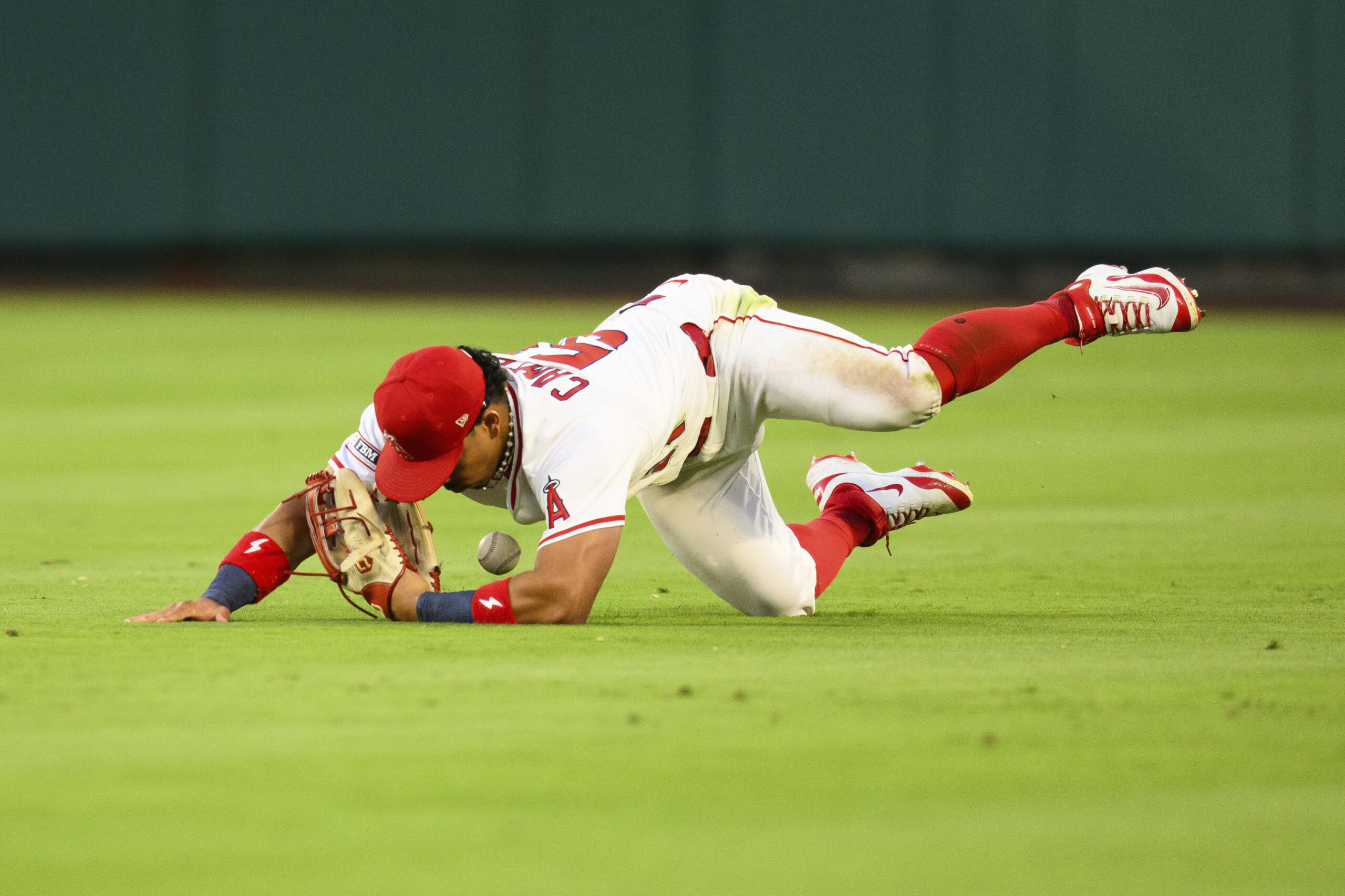 Angels right fielder Gustavo Campero makes an error while trying...