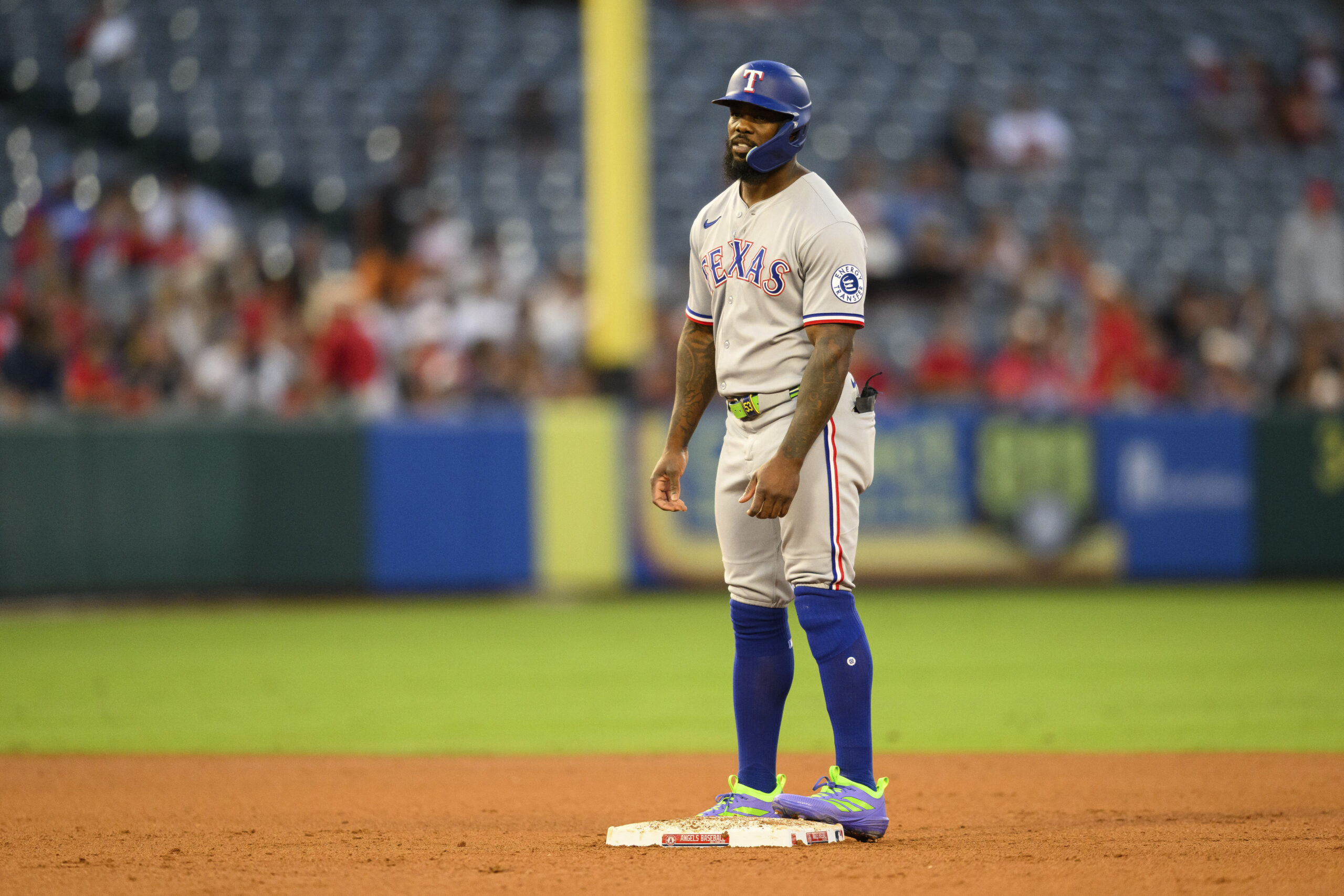 The Texas Rangers’ Adolis García reaches second base on an...