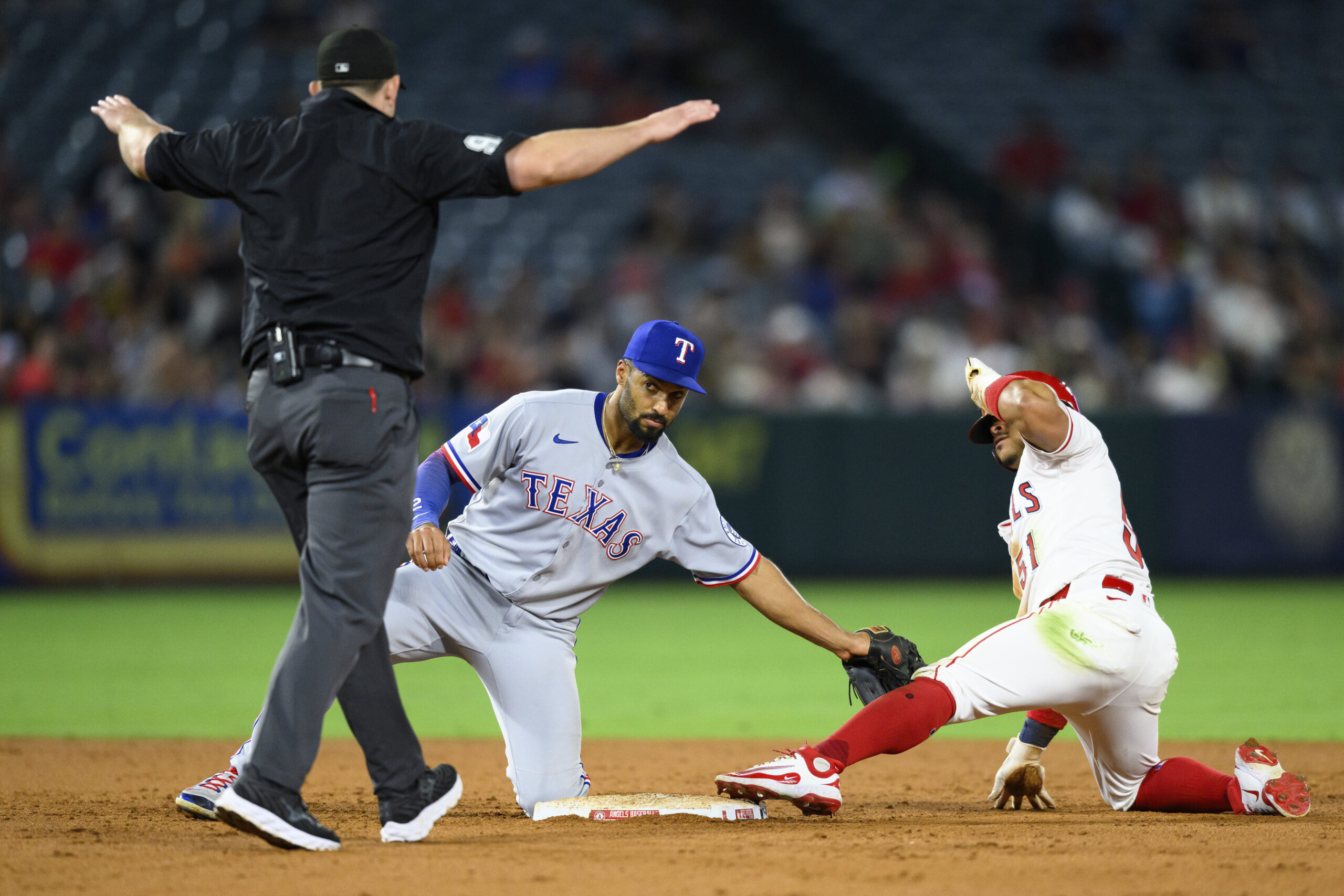 The Angels’ Gustavo Campero, right, safely steals second base during...