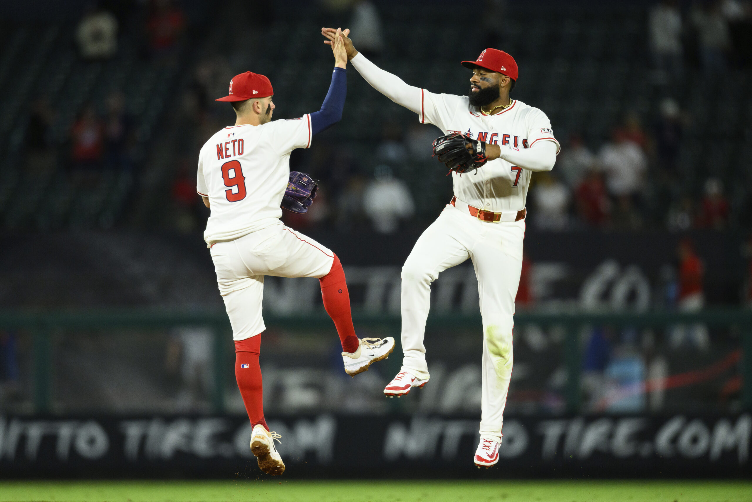 Angels center fielder Jo Adell, right, and shortstop Zach Neto...