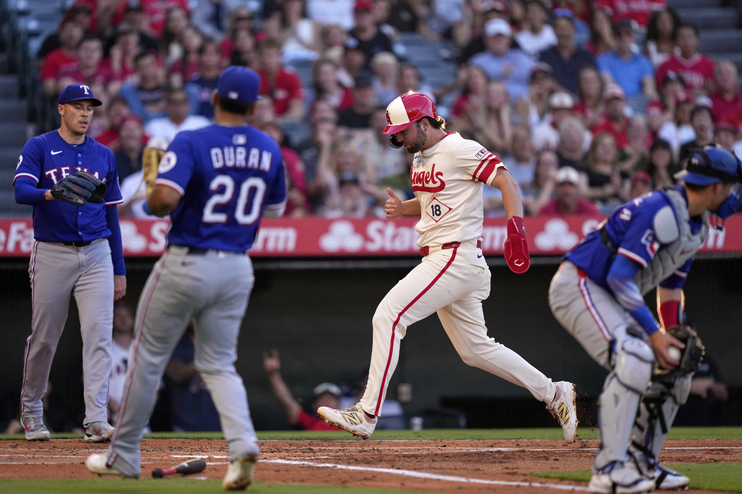 The Angels’ Nolan Schanuel, second from right, scores on a...