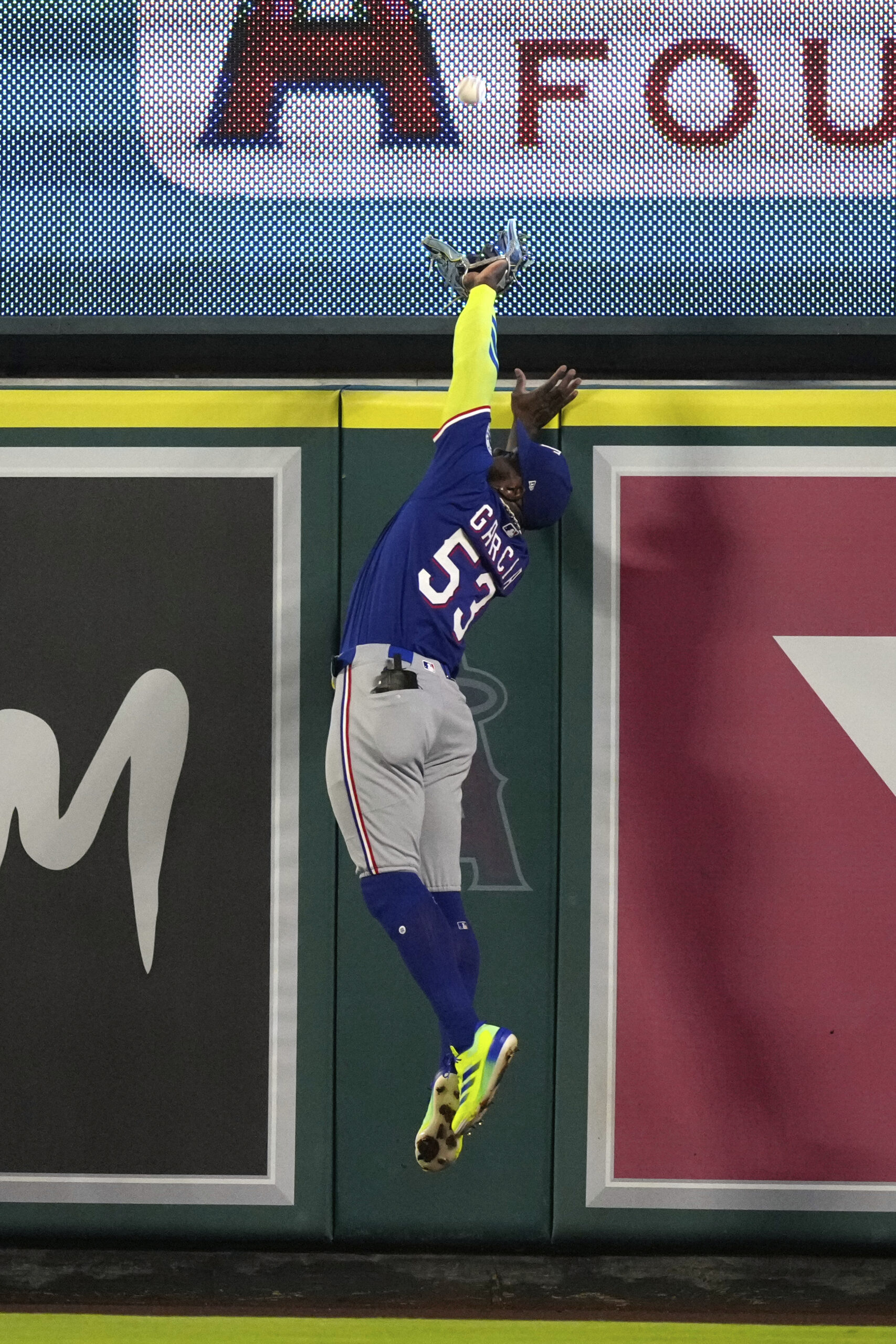 Texas Rangers right fielder Adolis Garcia makes a catch on...