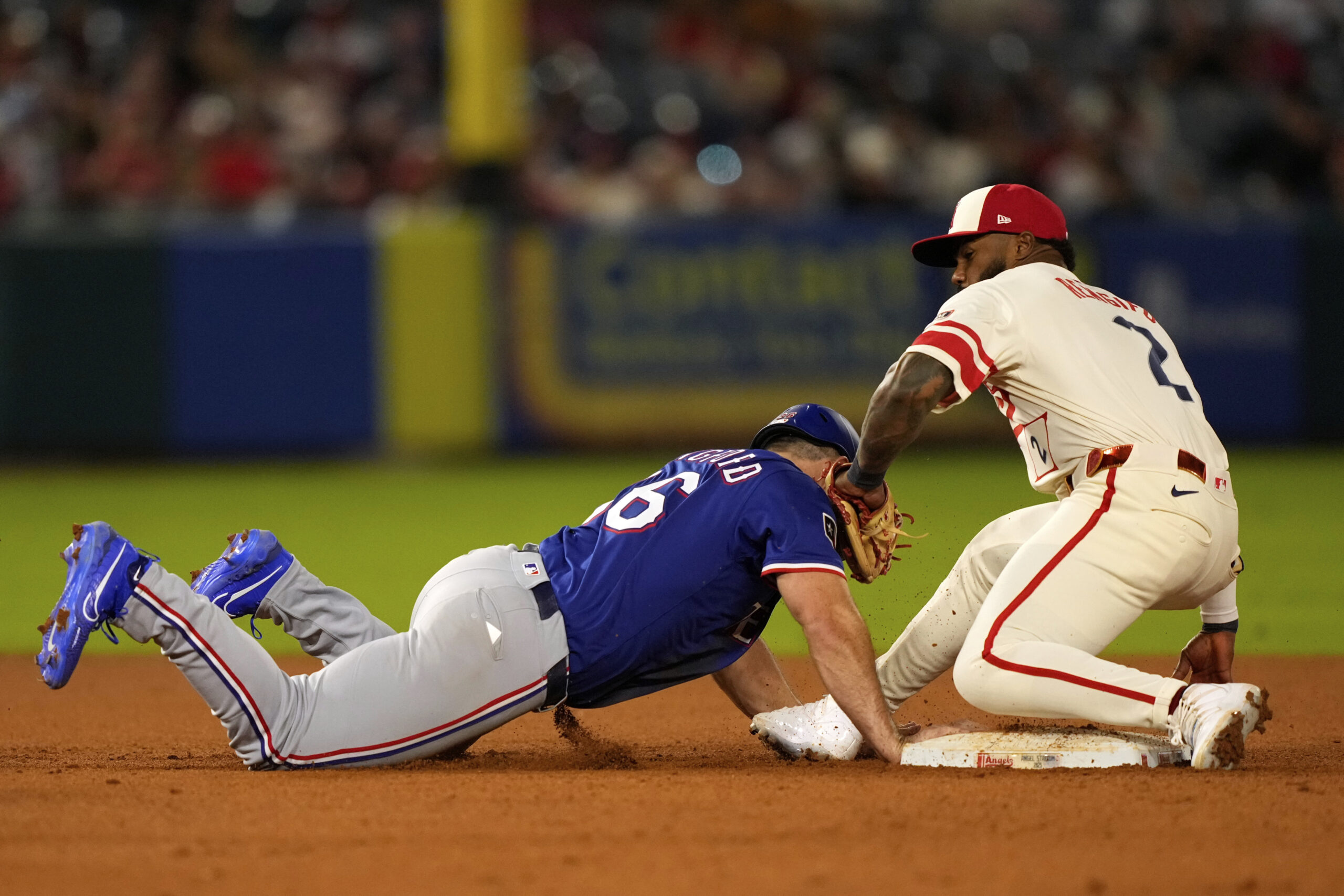 The Texas Rangers’ Wyatt Langford, left, is tagged out at...