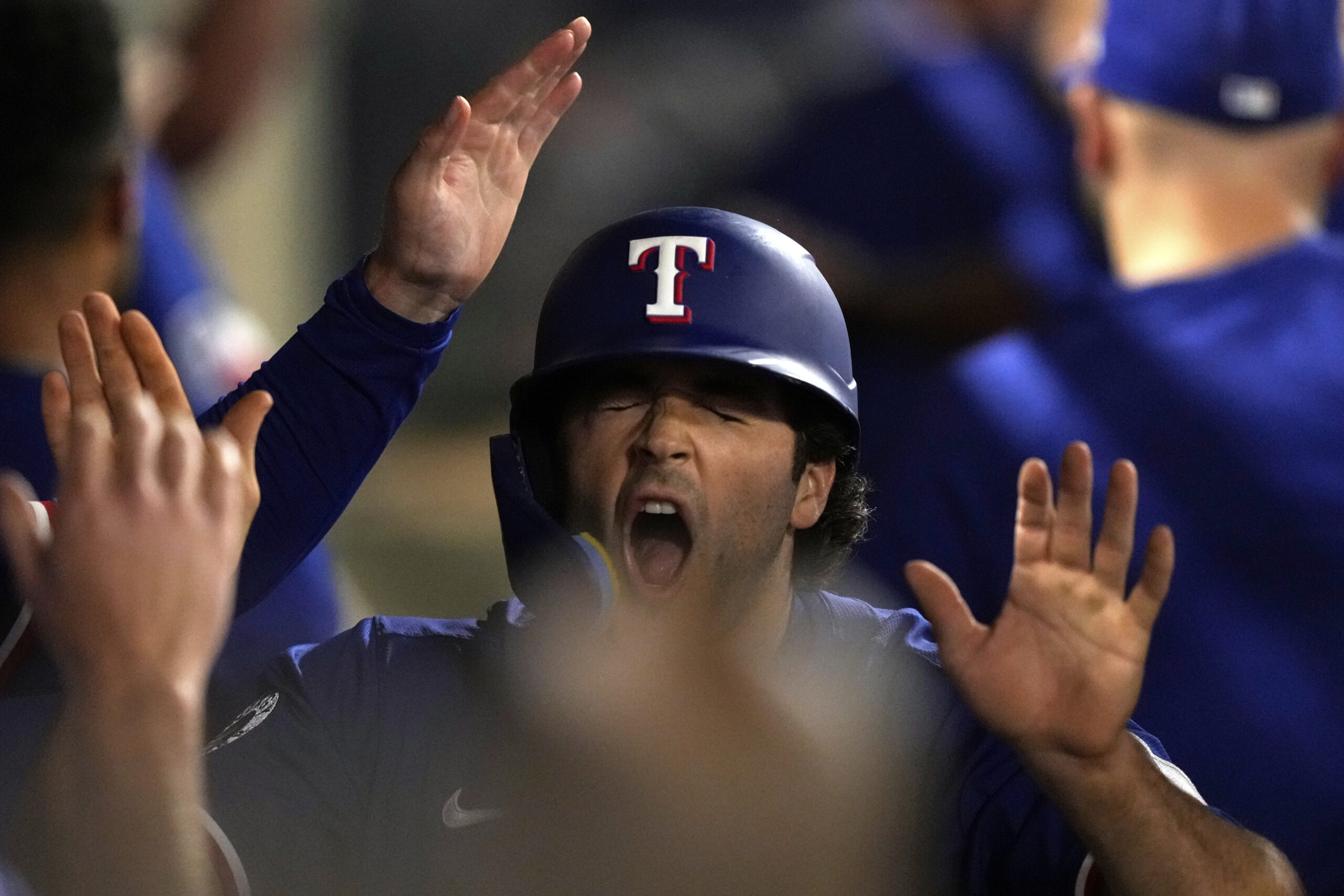 The Texas Rangers’ Josh Smith is congratulated by teammates in...