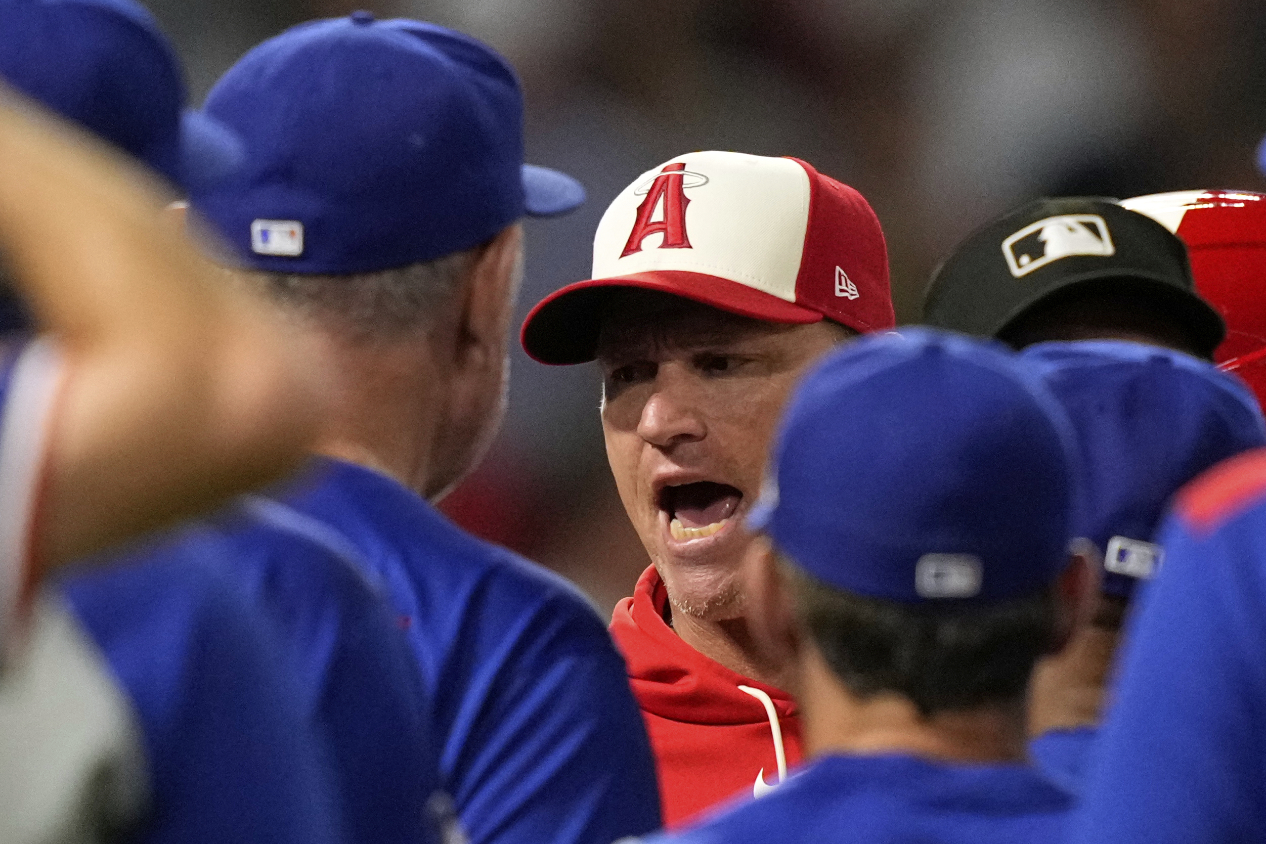 Angels interim manager Ray Montgomery, center, has words with Texas...