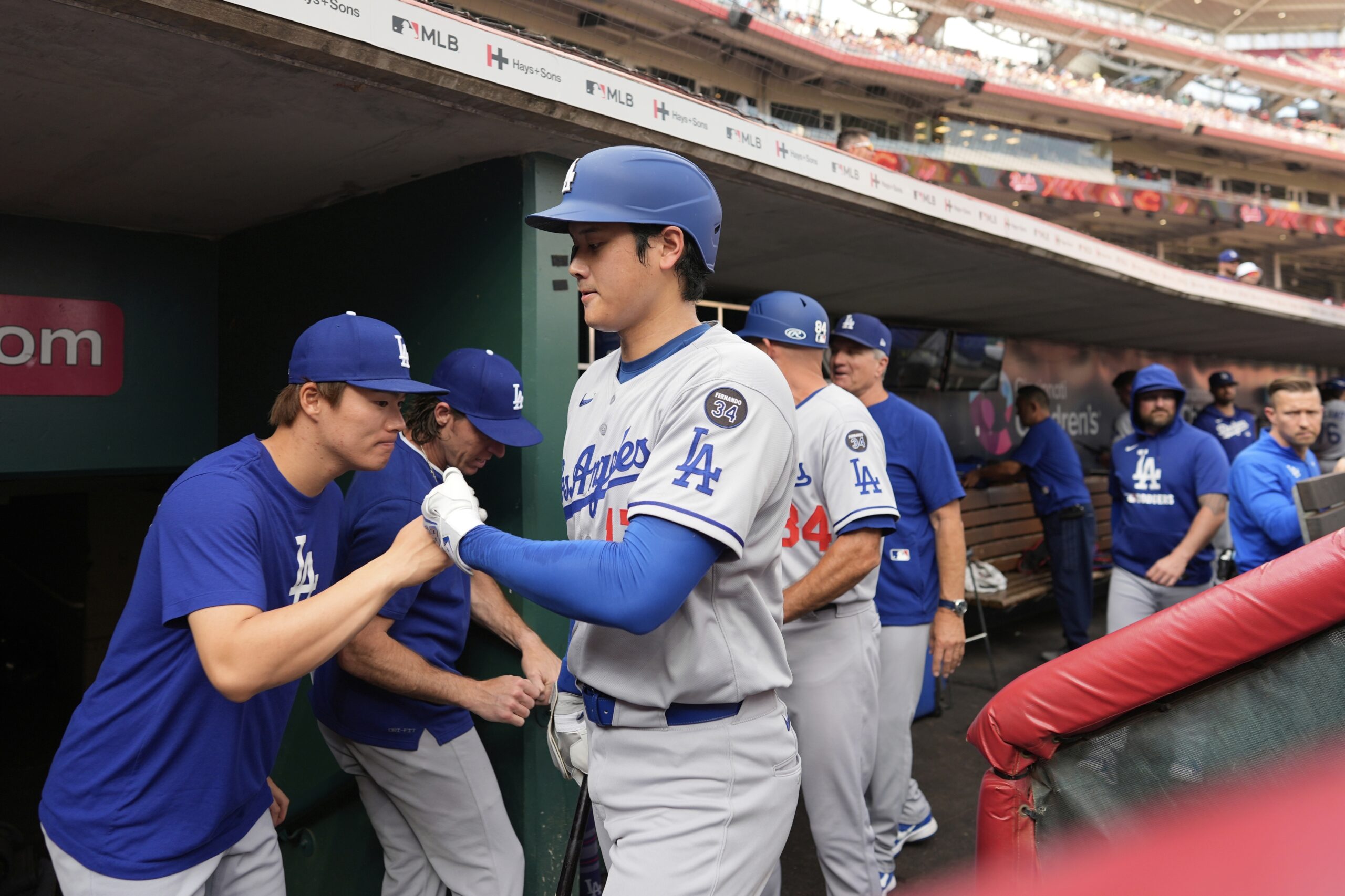 Dodgers star Shohei Ohtani, right, fist-bumps teammate Yoshinobu Yamamoto before...