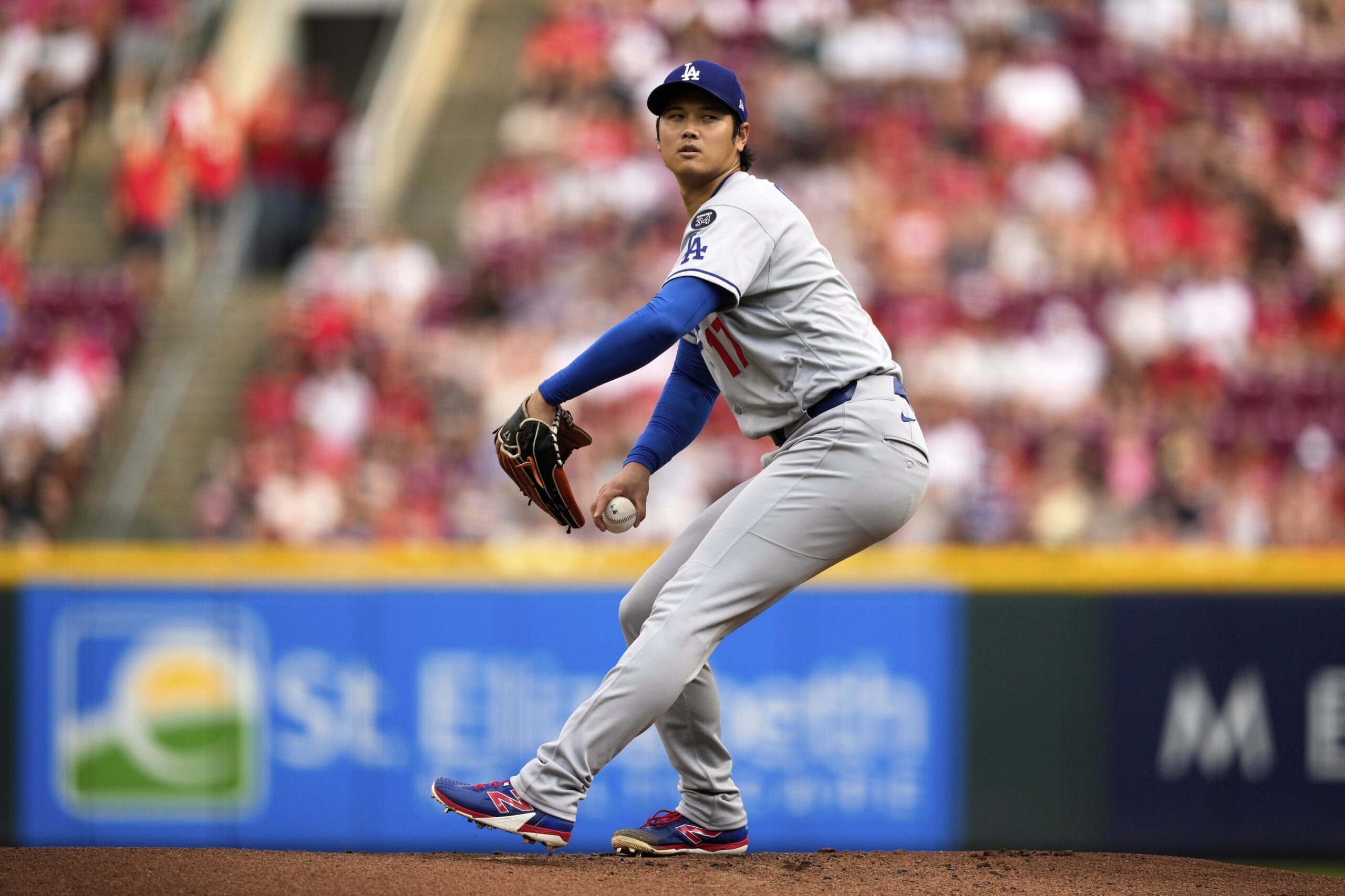 Dodgers starting pitcher Shohei Ohtani throws to the plate during...