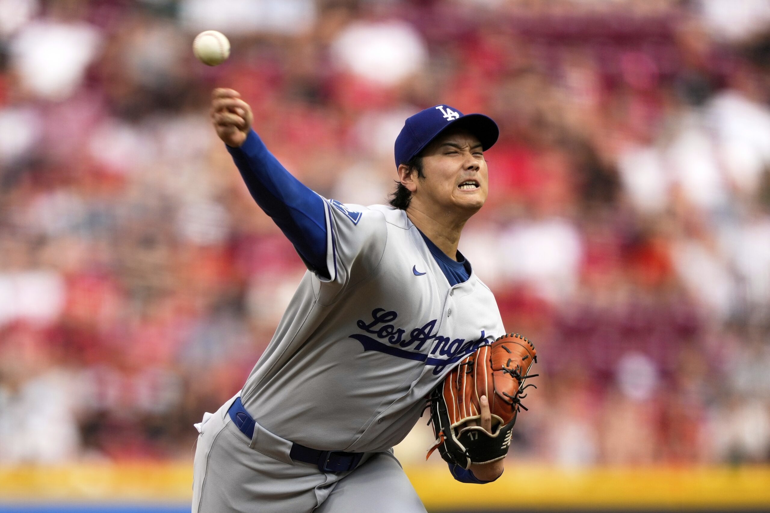 Dodgers starting pitcher Shohei Ohtani throws to the plate during...