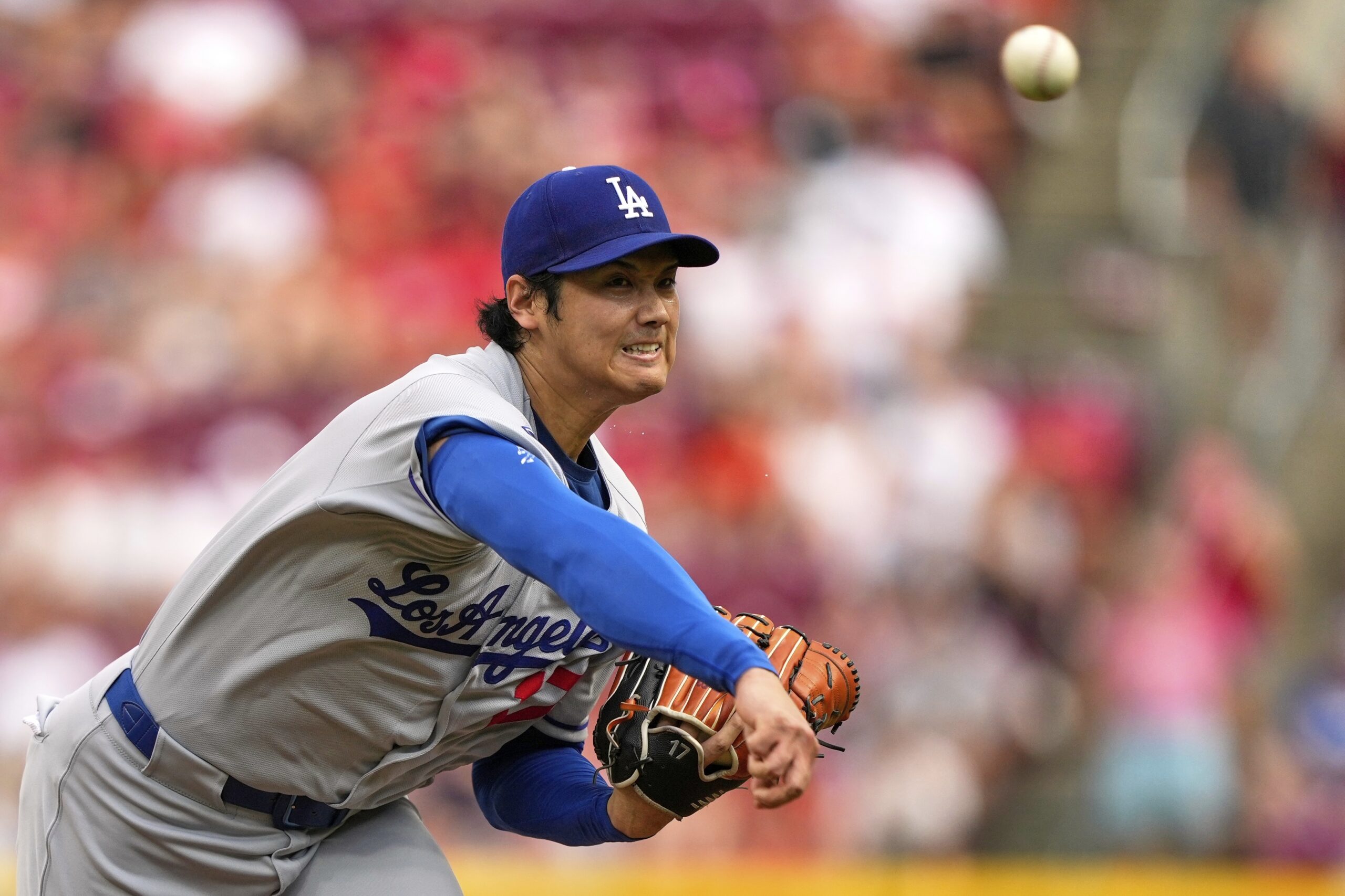 Dodgers starting pitcher Shohei Ohtani throws to the plate during...
