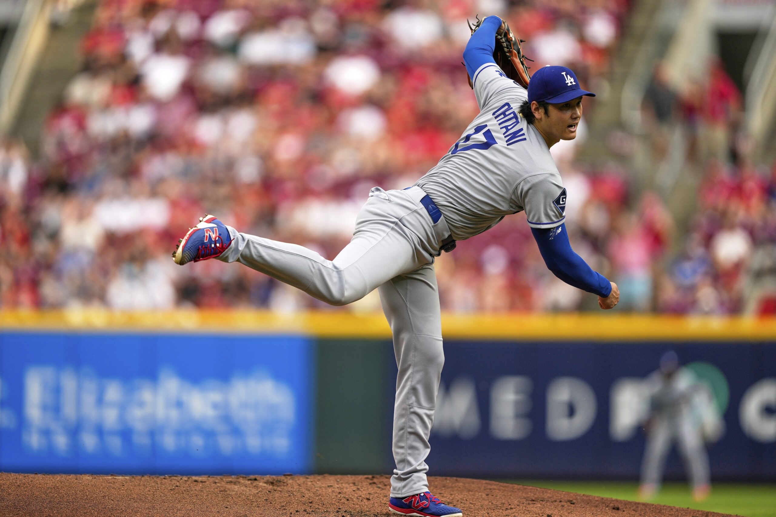 Dodgers starting pitcher Shohei Ohtani throws to the plate during...