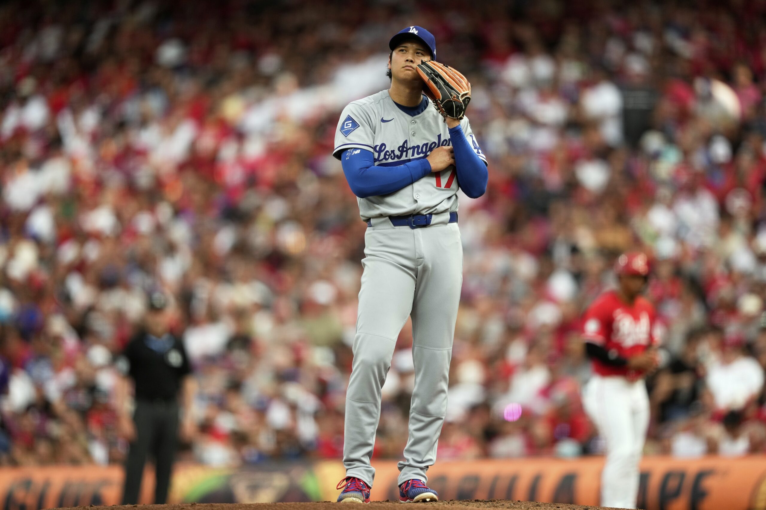 Dodgers starting pitcher Shohei Ohtani pauses during the second inning...