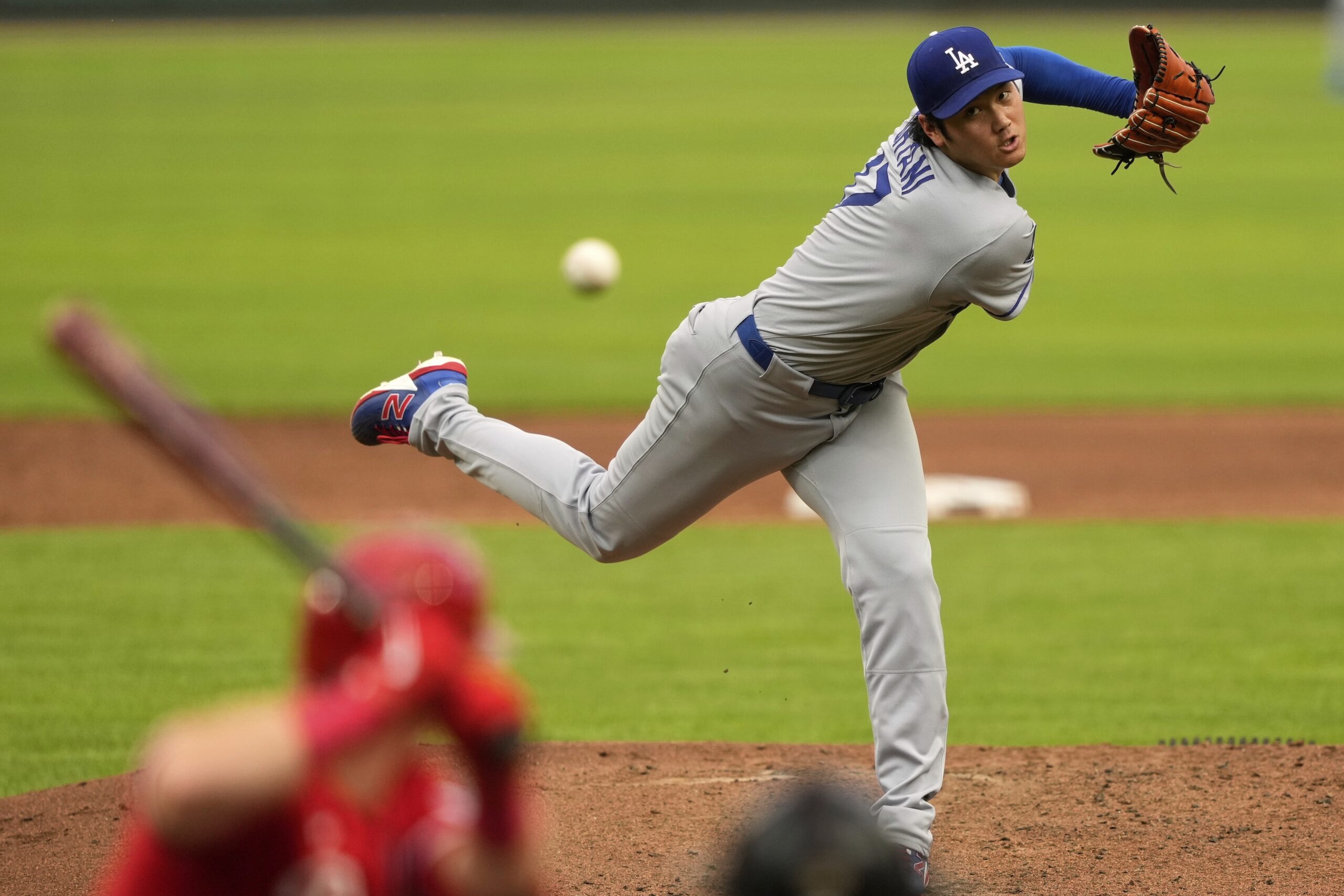 Dodgers starting pitcher Shohei Ohtani throws to the plate during...