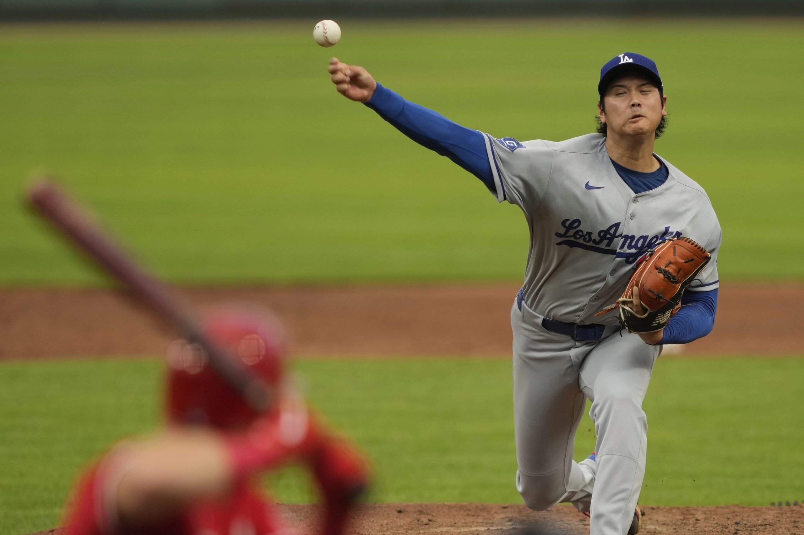 Dodgers starting pitcher Shohei Ohtani throws to the plate during...