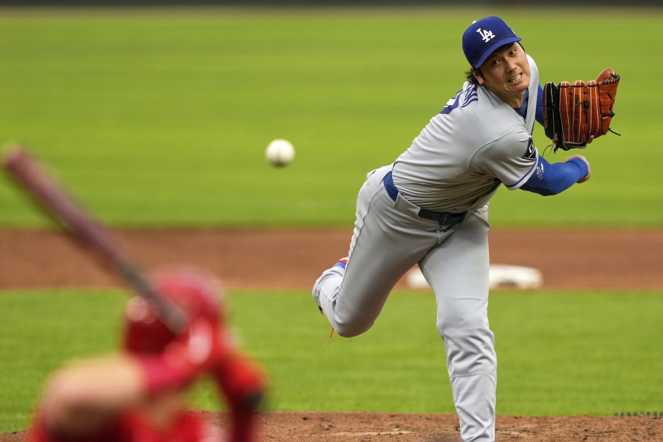 Dodgers starting pitcher Shohei Ohtani throws to the plate during...
