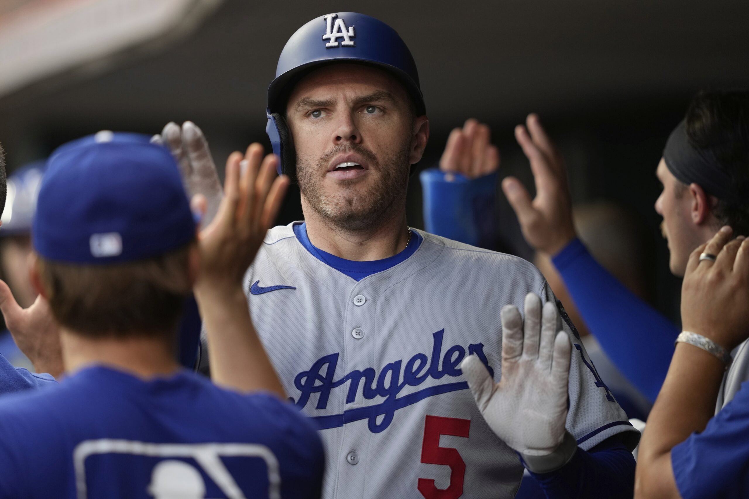 The Dodgers’ Freddie Freeman is congratulated in the dugout after...