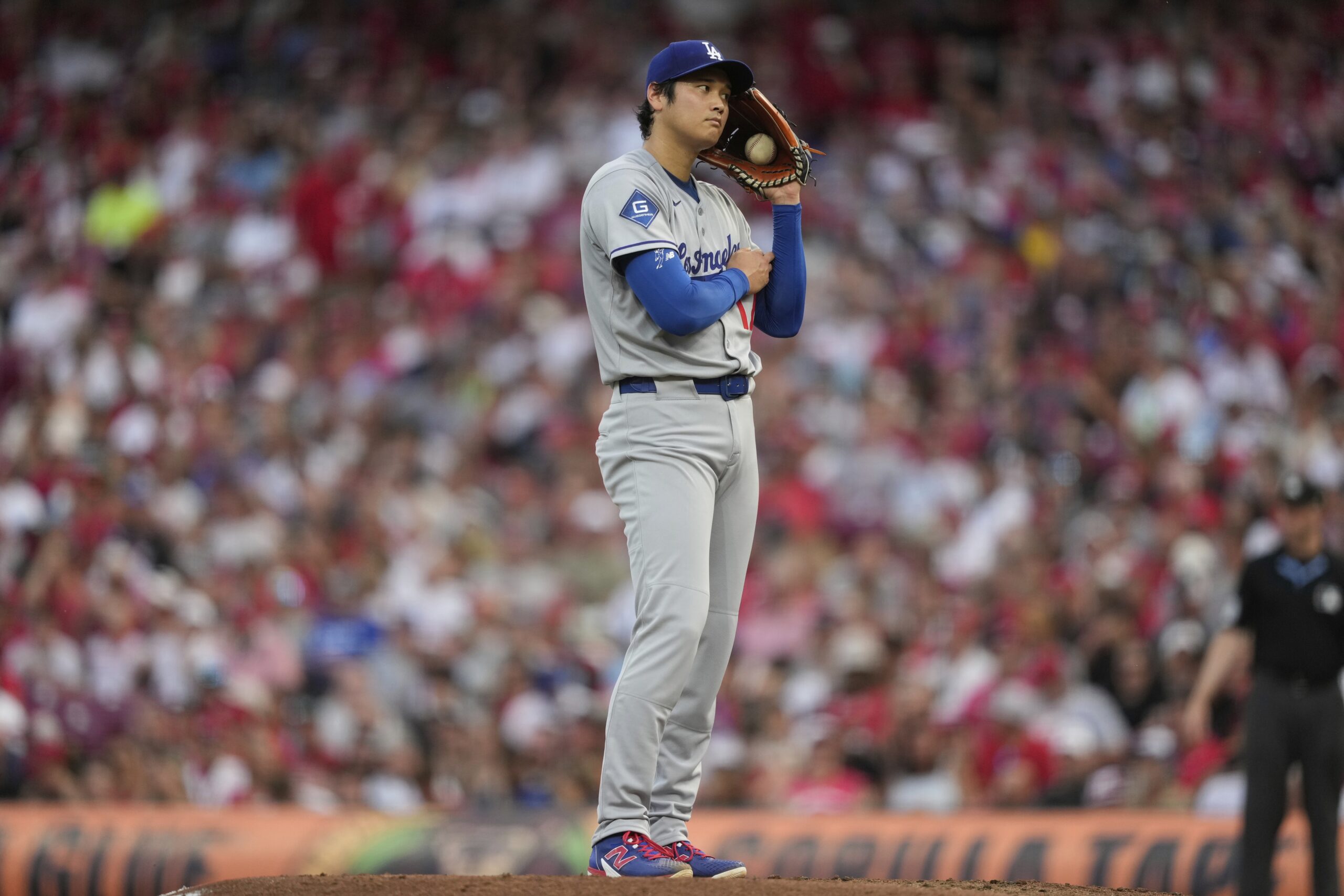 Dodgers starting pitcher Shohei Ohtani pauses as he listens to...