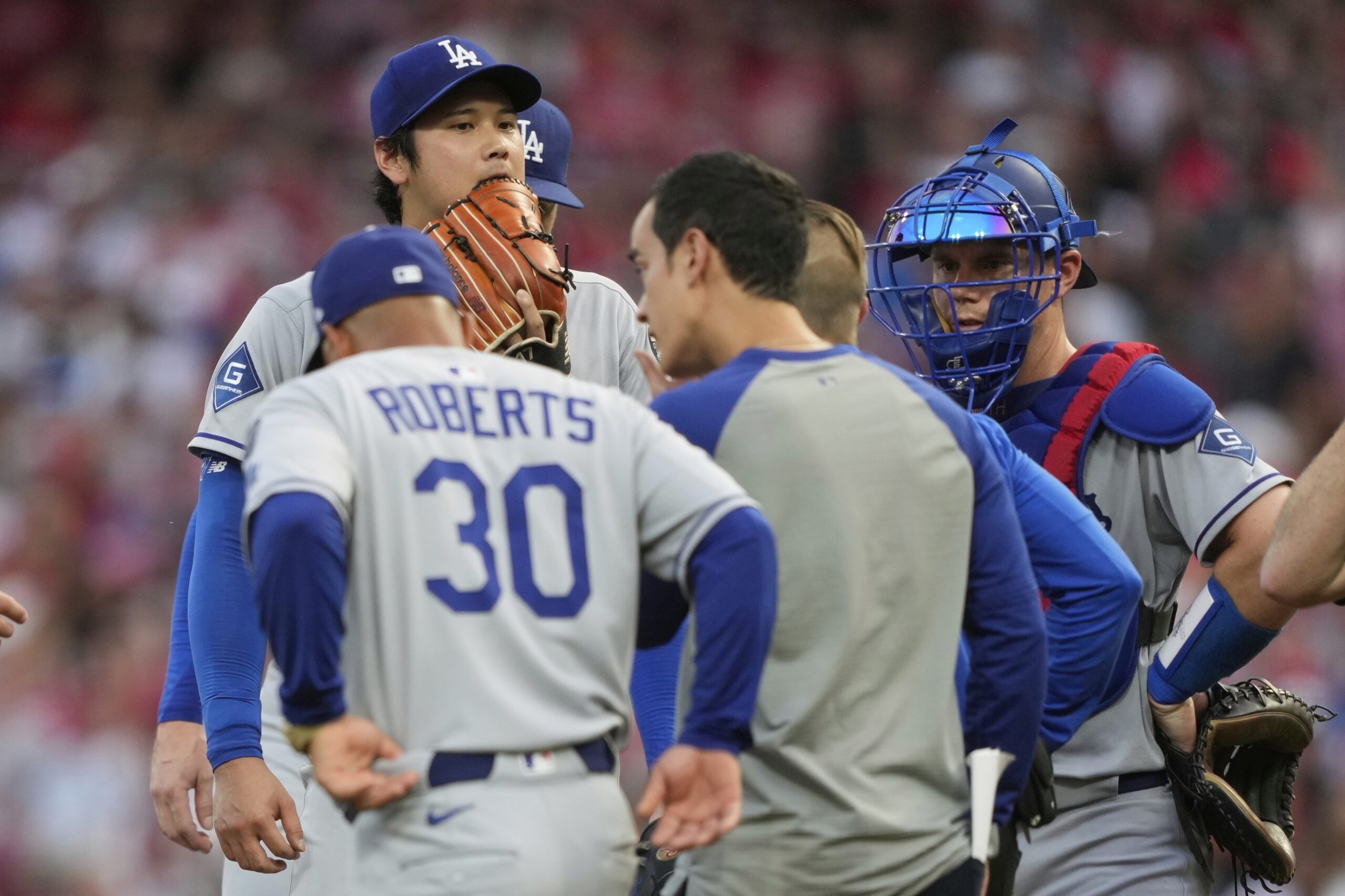 Dodgers starting pitcher Shohei Ohtani, top left, is removed during...
