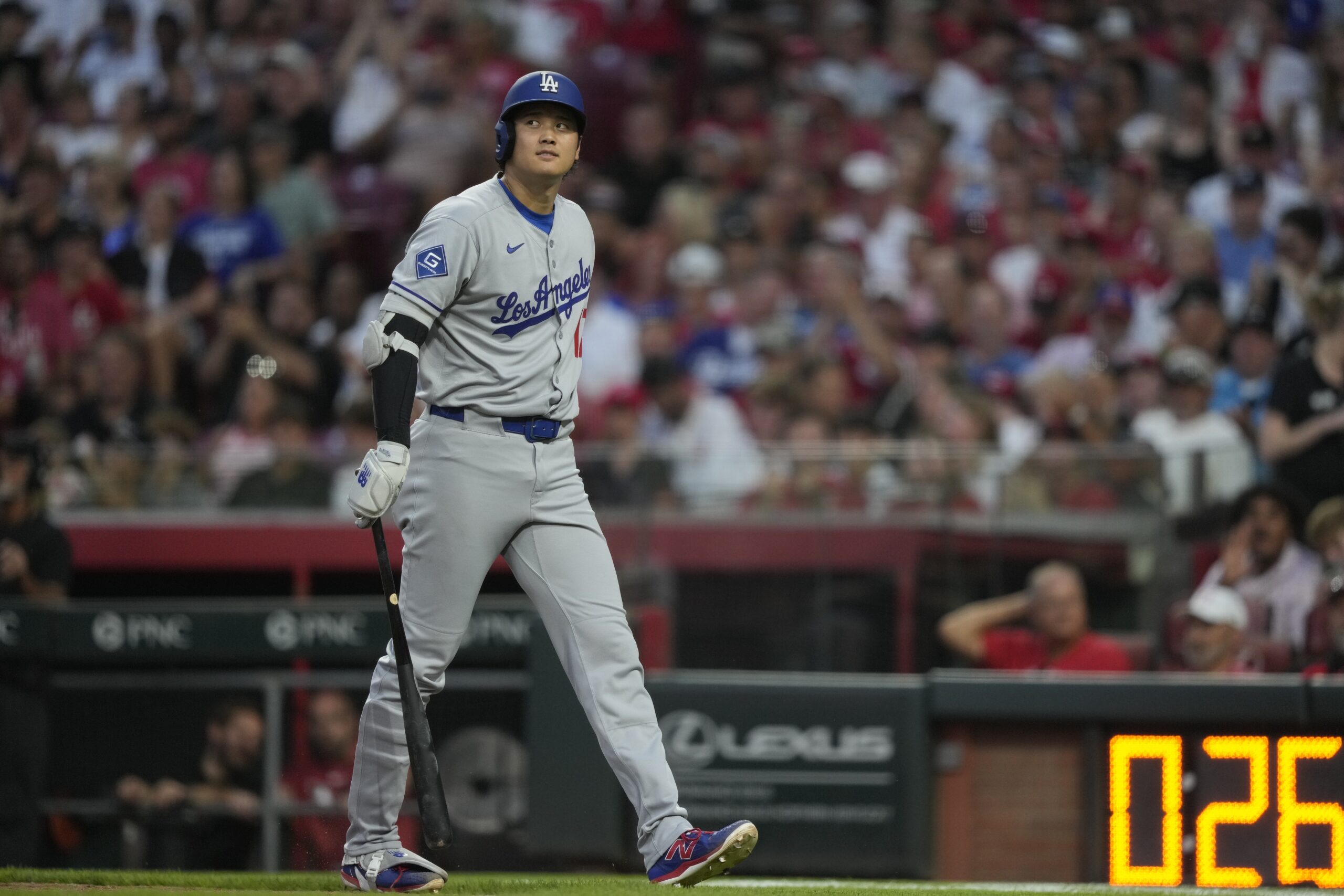 Dodgers star Shohei Ohtani walks to te dugout after batting...