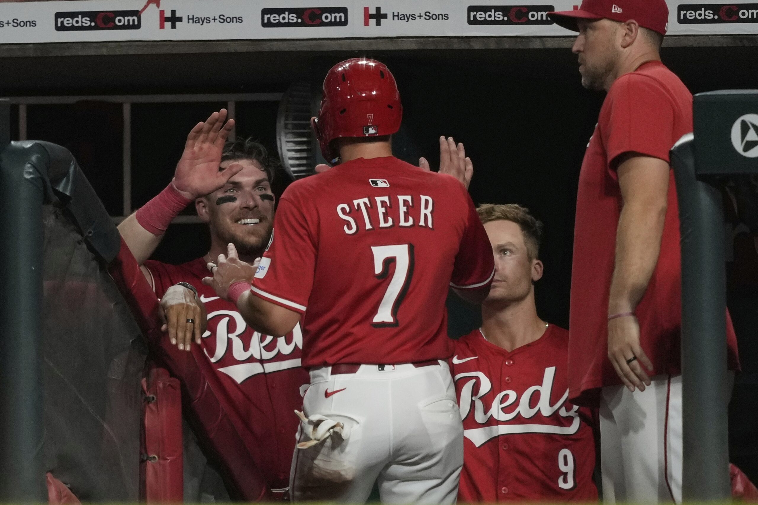 The Cincinnati Reds’ Spencer Steer is congratulated after scoring during...