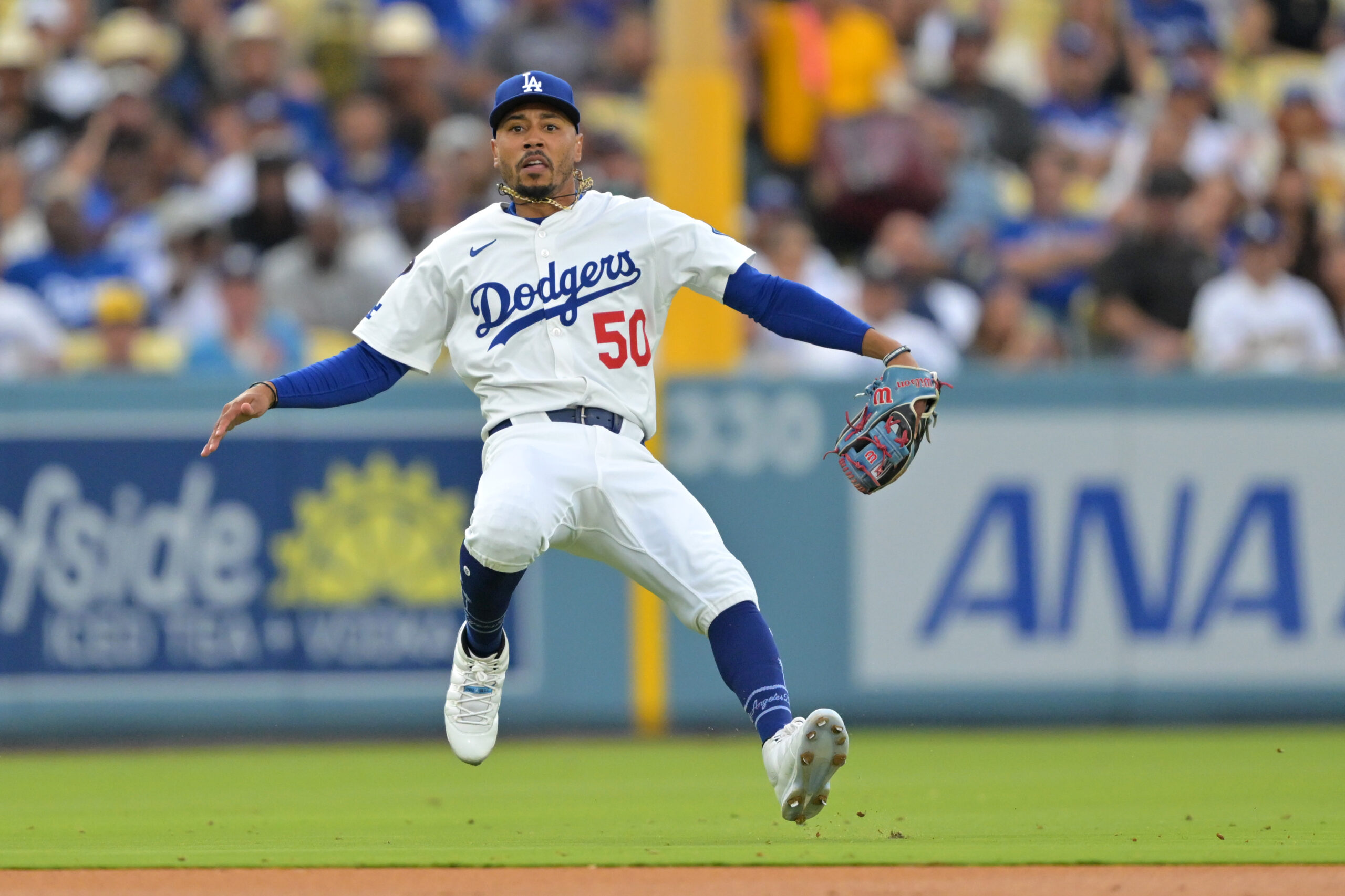 Dodgers shortstop Mookie Betts makes a leaping throw but is...