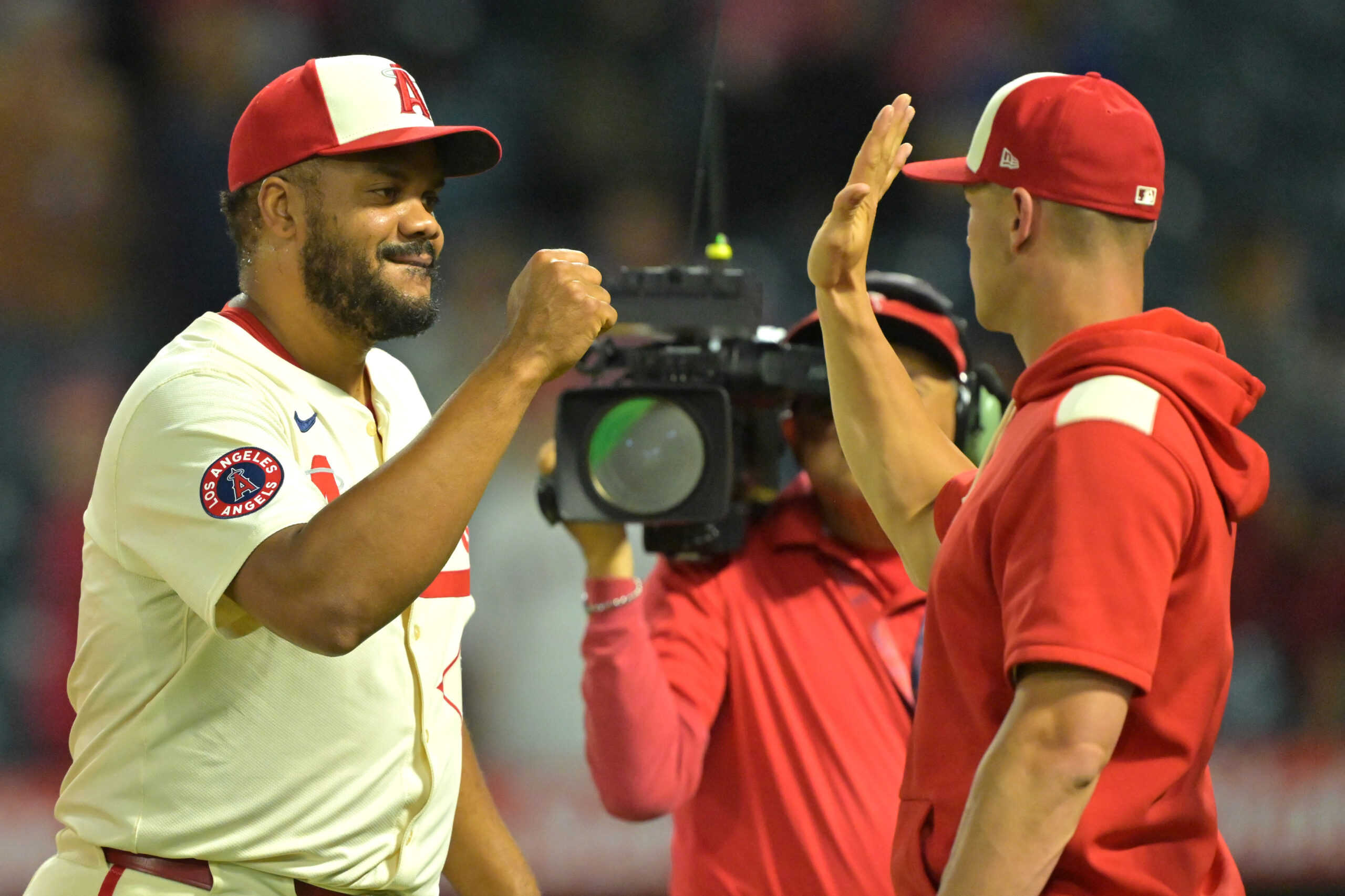 Angels relief pitcher Kenley Jansen, left, celebrates his 20th save...