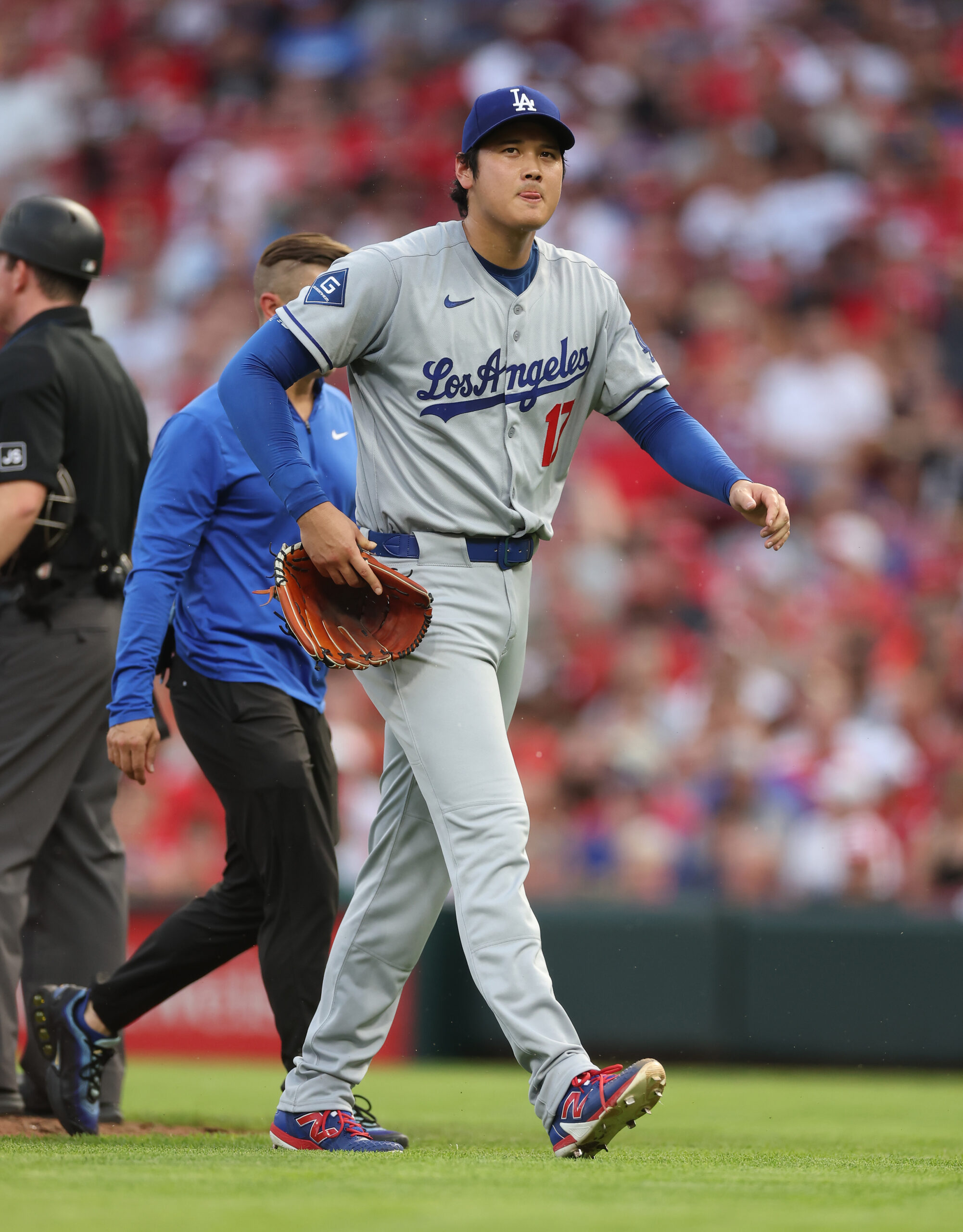 Dodgers starting pitcher Shohei Ohtani walks to the dugout after...