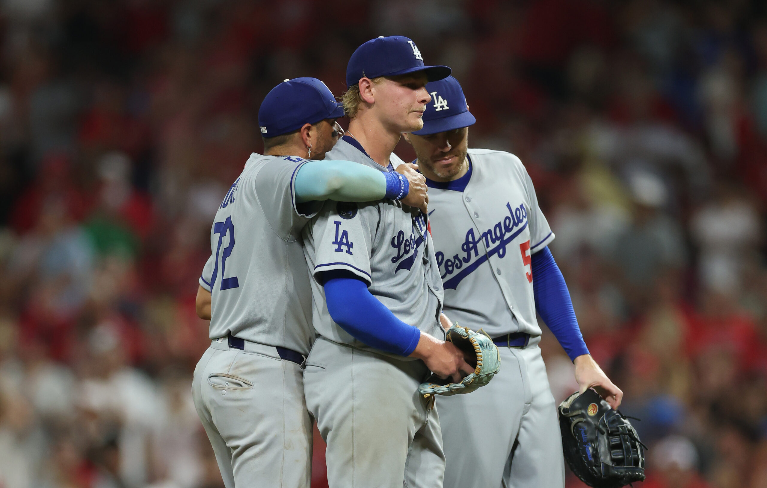 Dodgers relief pitcher Emmet Sheehan, center, is consoled by shortstop...
