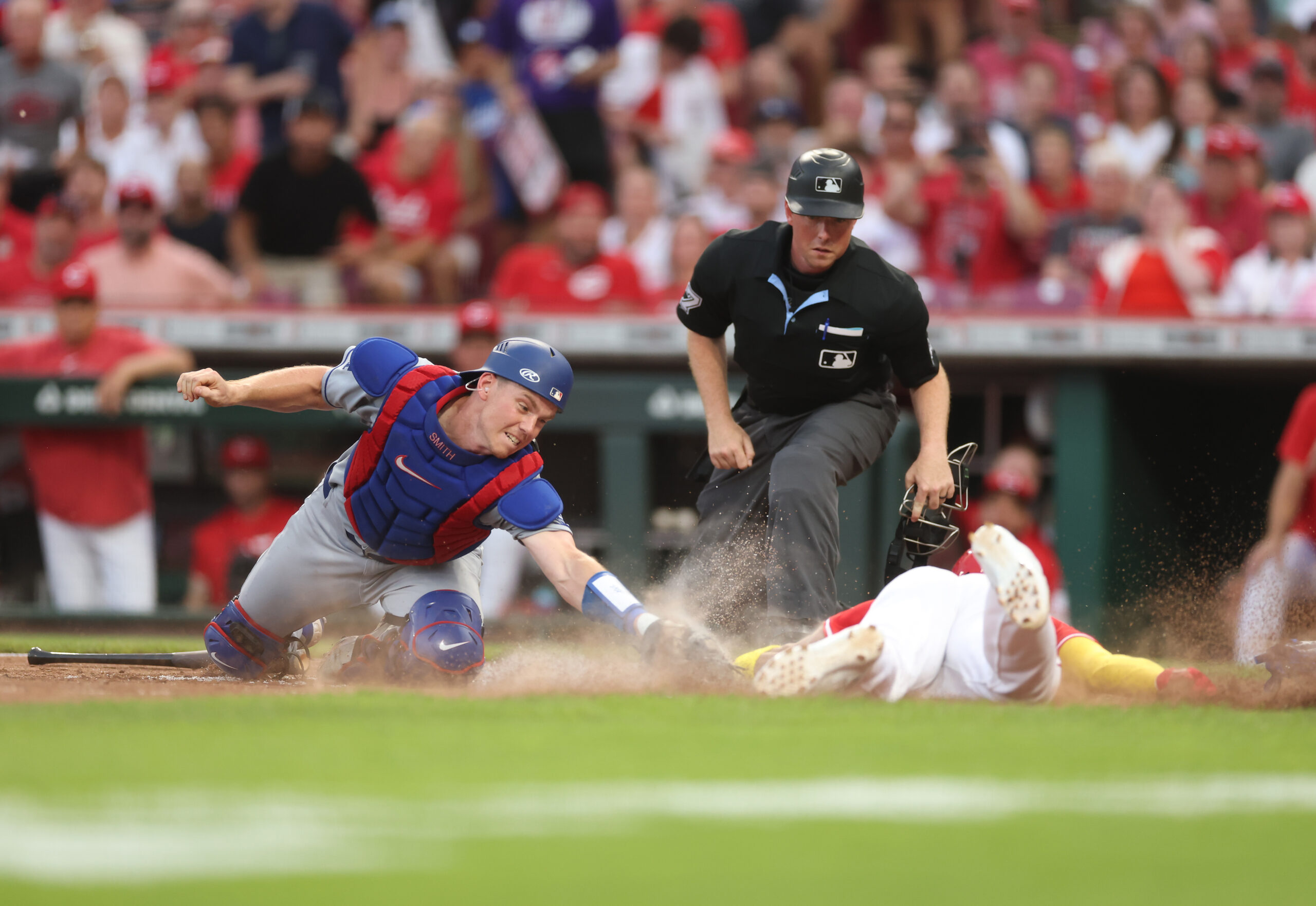 The Cincinnati Reds’ Noelvi Marte scores ahead of the tag...