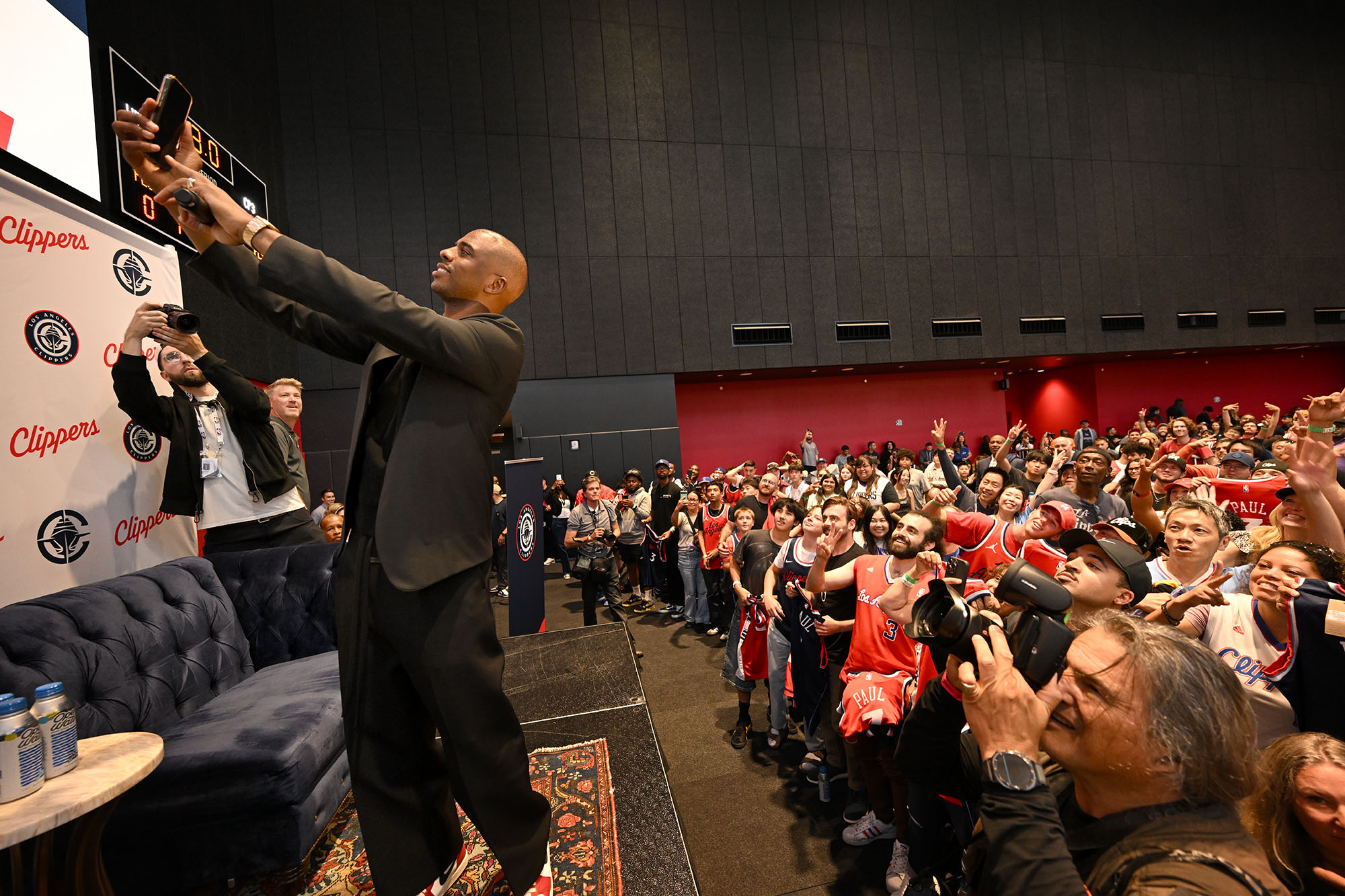 Clippers guard Chris Paul takes a selfie with fans after...