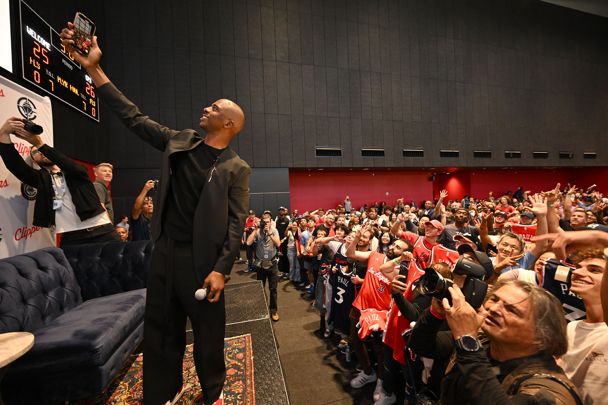 Clippers guard Chris Paul takes a selfie with fans after...