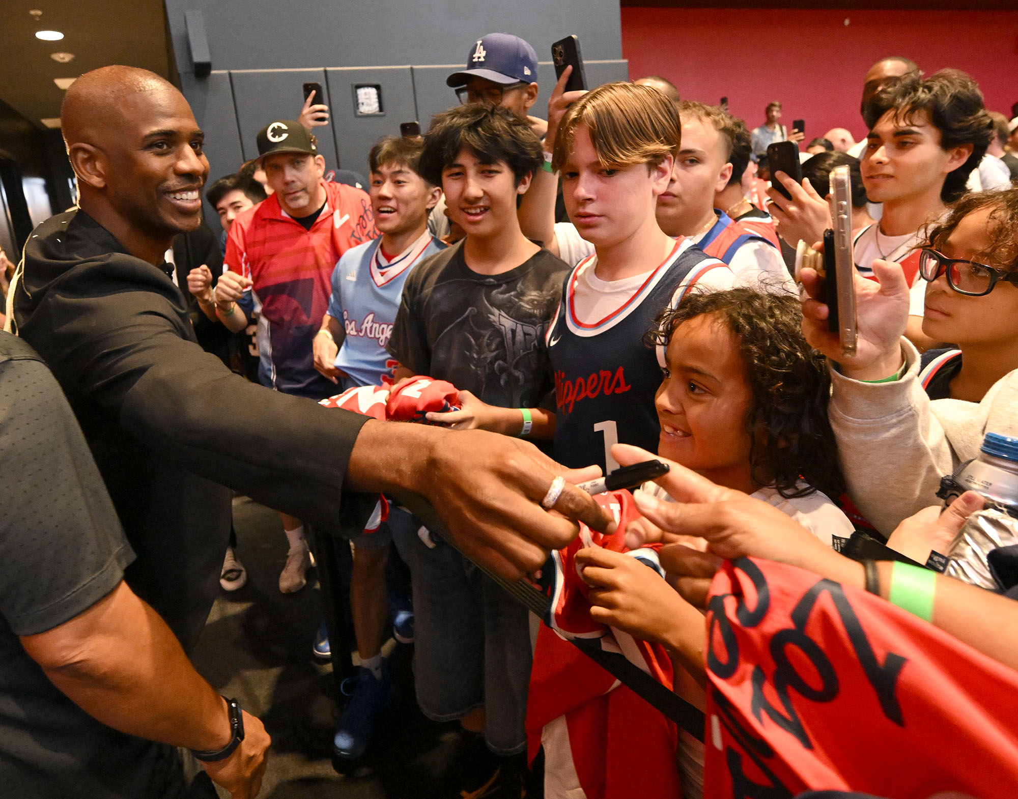 Clippers guard Chris Paul signs autographs after being welcomed back...