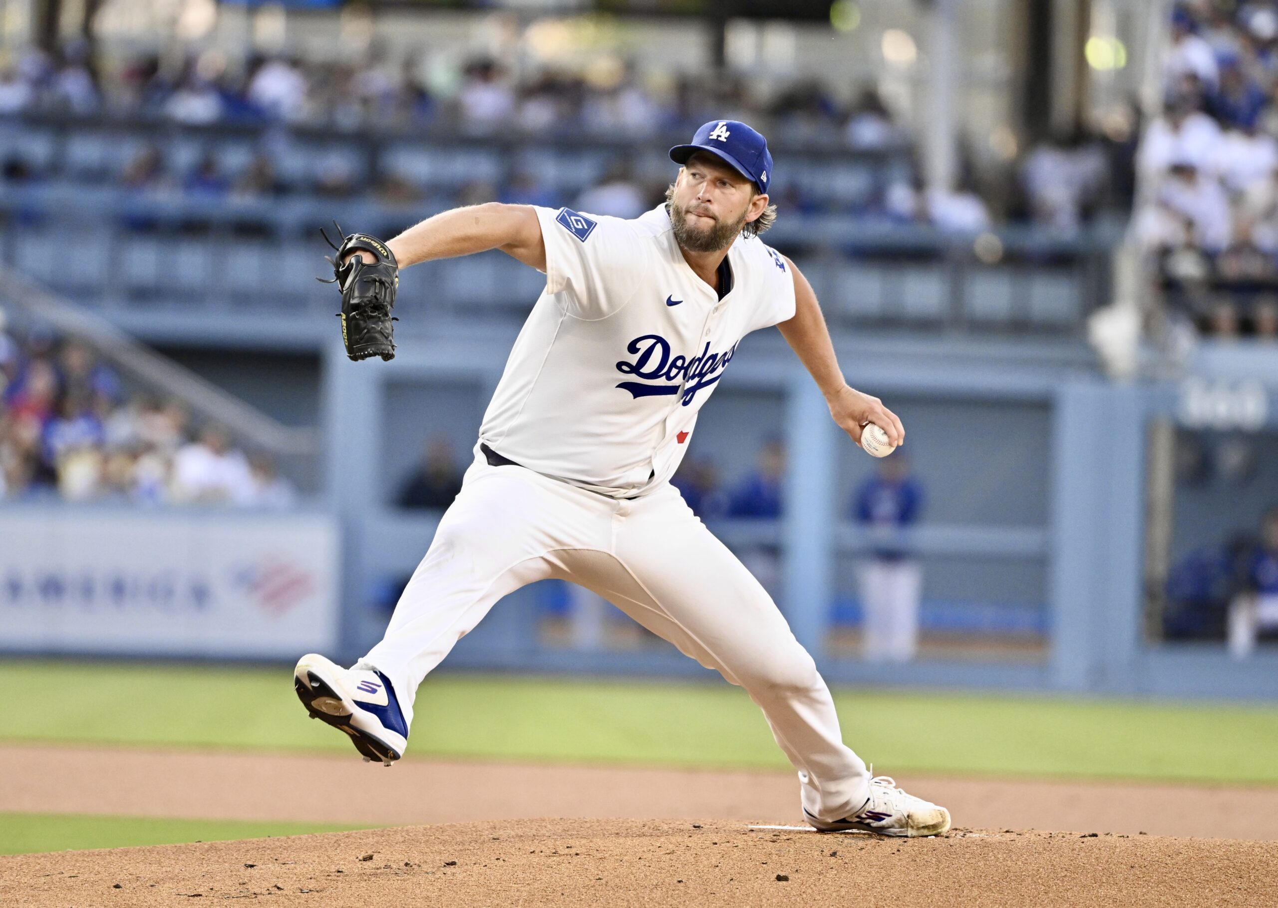 Dodgers starting pitcher Clayton Kershaw throws to the plate during...