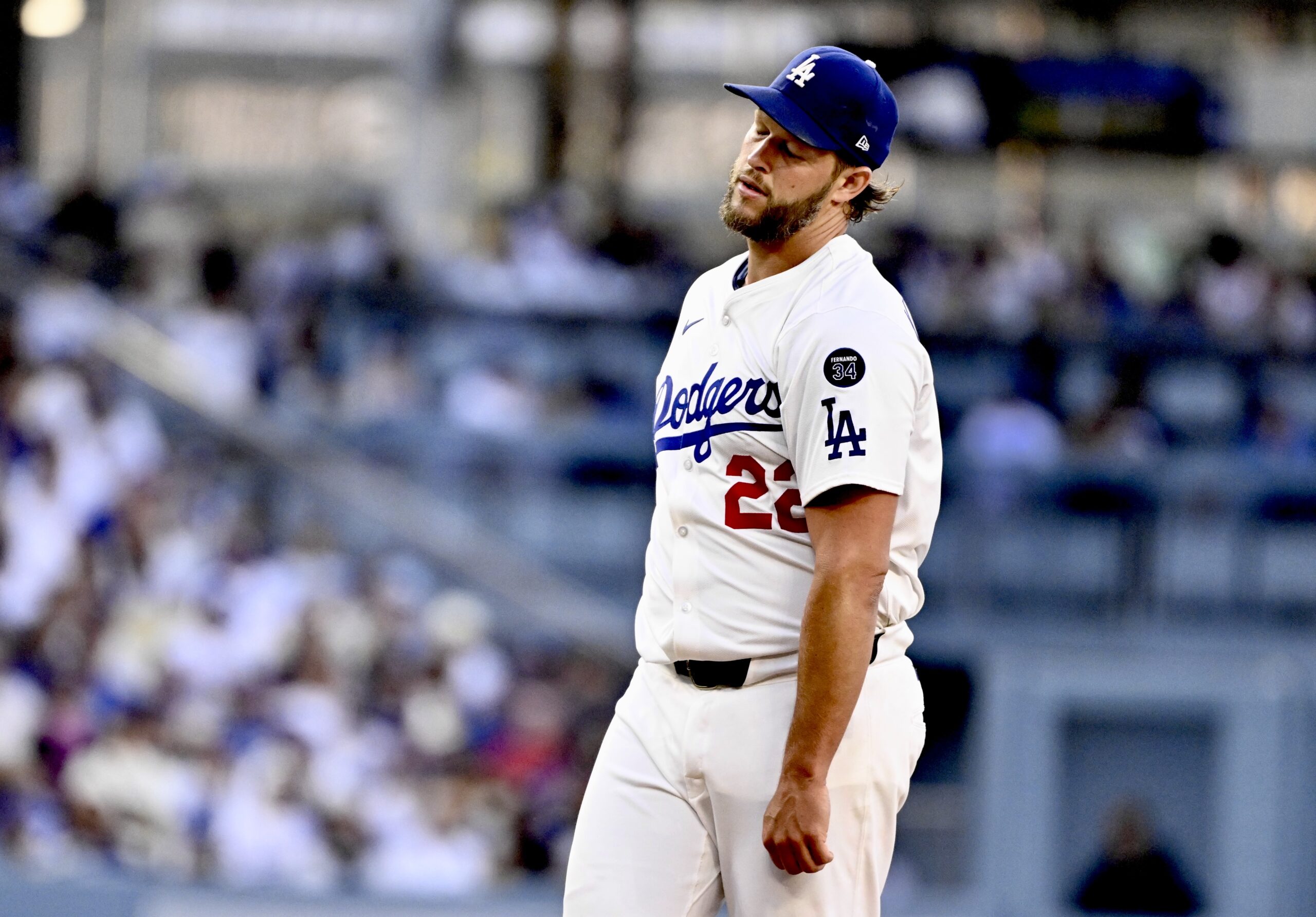 Dodgers starting pitcher Clayton Kershaw reacts after giving up a...