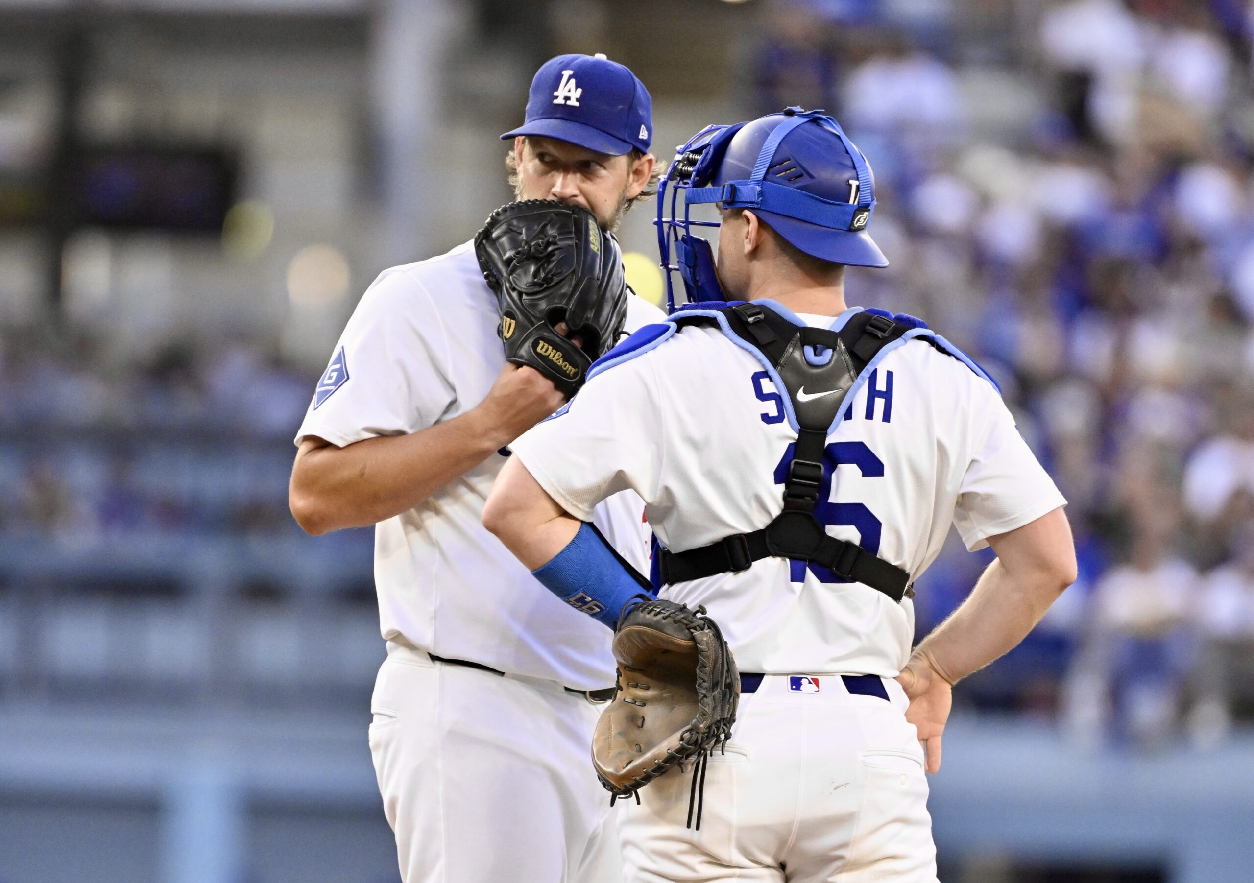 Dodgers starting pitcher Clayton Kershaw, left, talks with catcher Will...