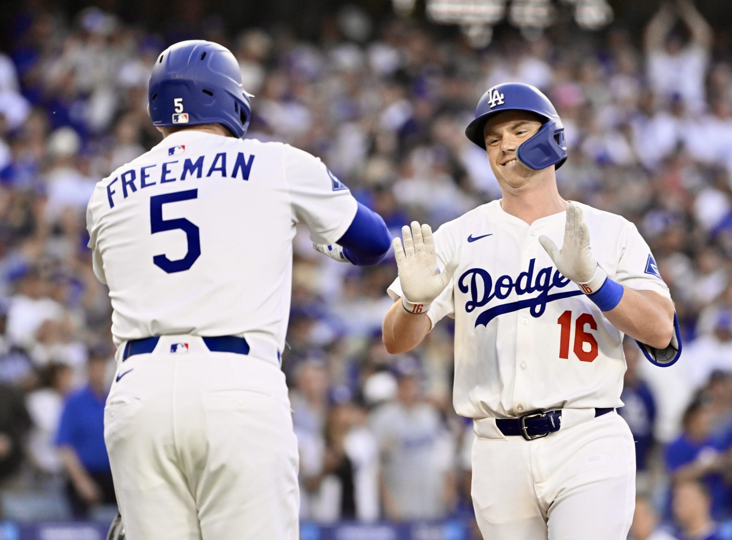 The Dodgers’ Will Smith, right, is greeted by teammate Freddie...