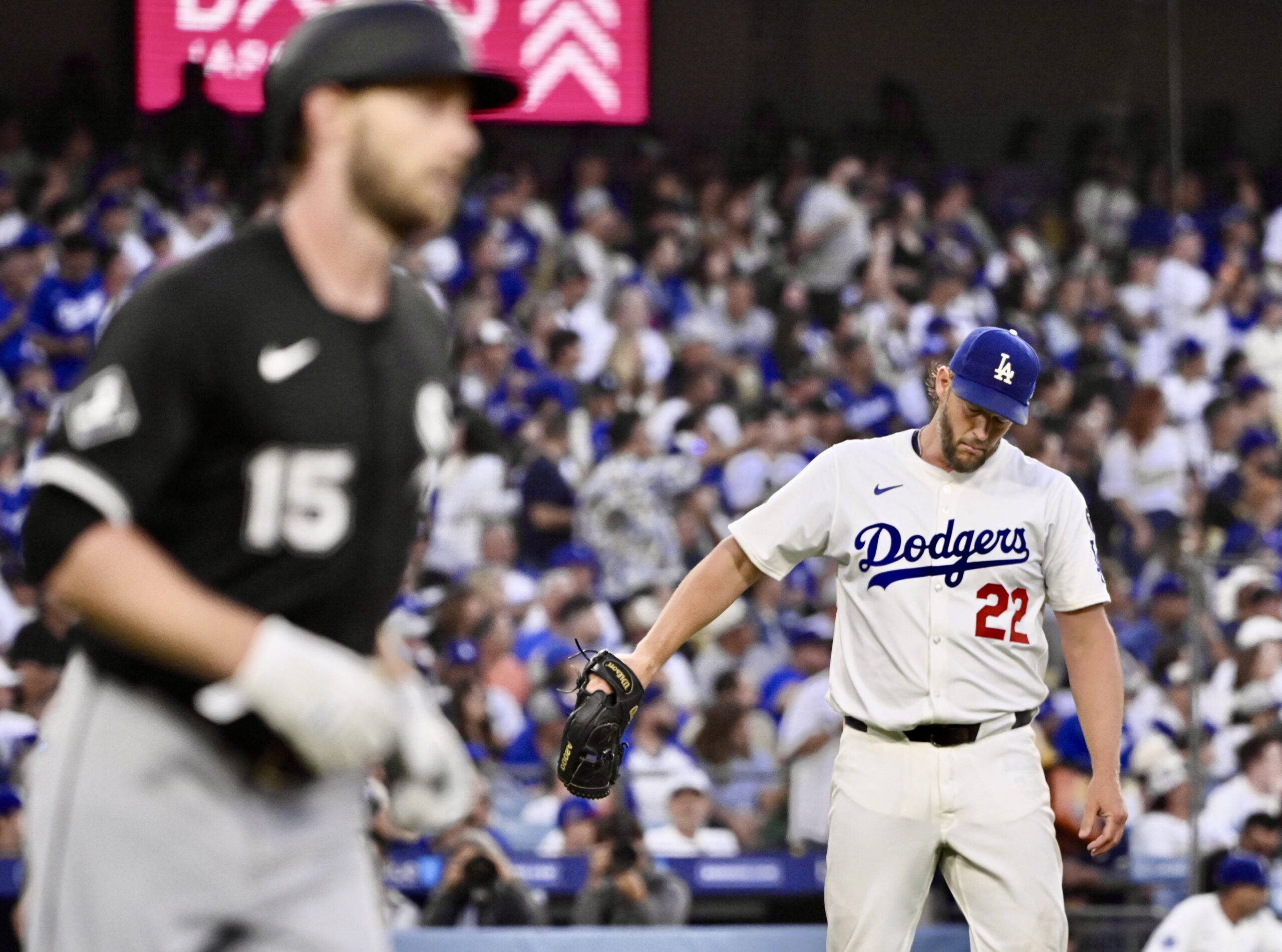 Dodgers starting pitcher Clayton Kershaw, right, shows his frustration after...