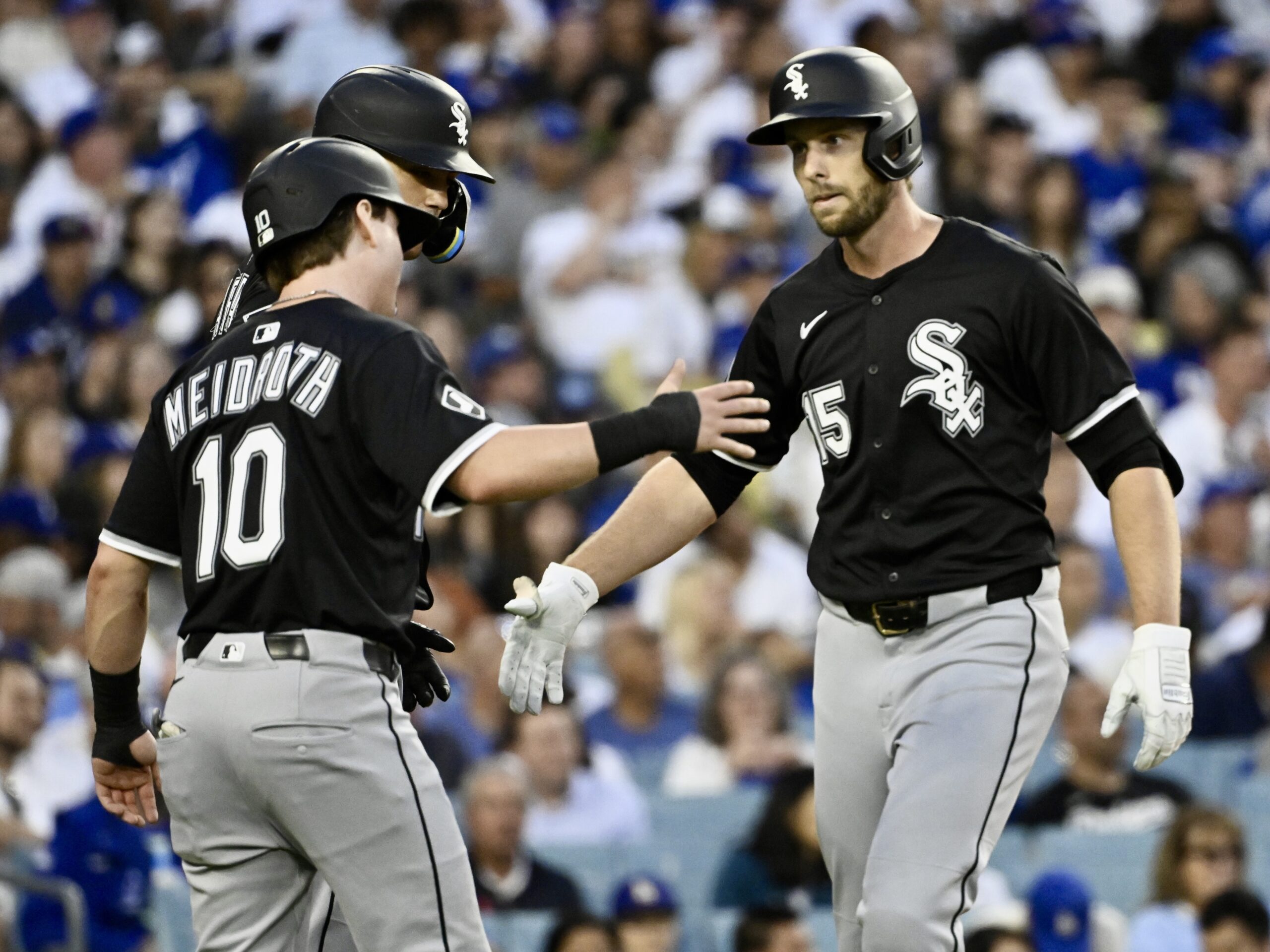 The Chicago White Sox’s Austin Slater, right, is greeted by...