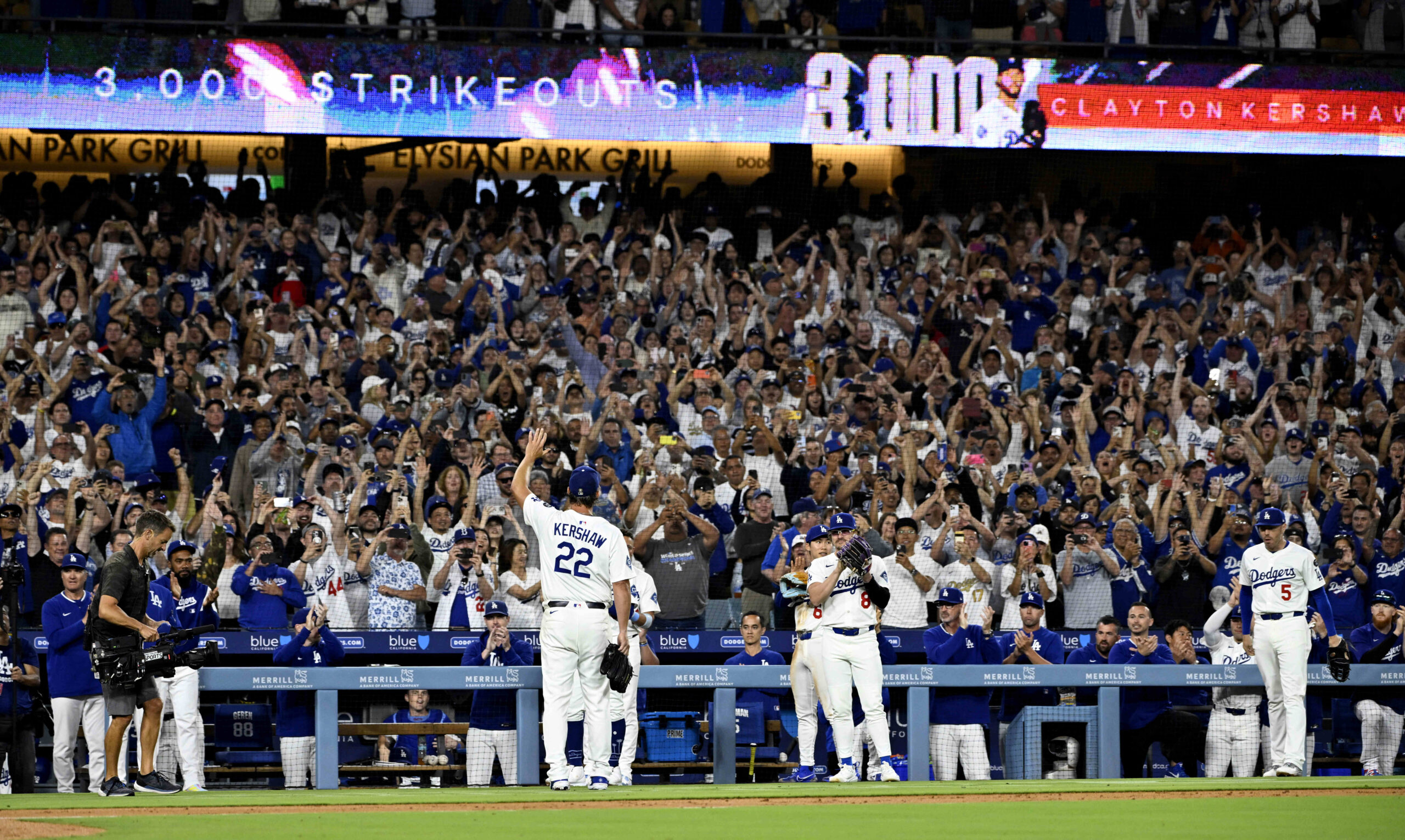 Dodgers starting pitcher Clayton Kershaw waves to the crowd after...