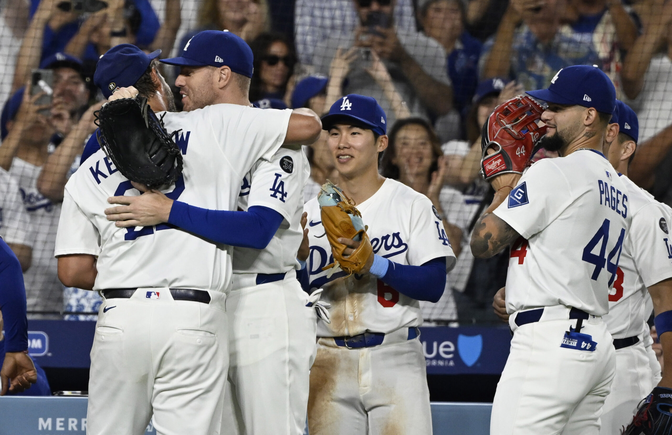 Dodgers starting pitcher Clayton Kershaw, left, hugs first baseman Freddie...