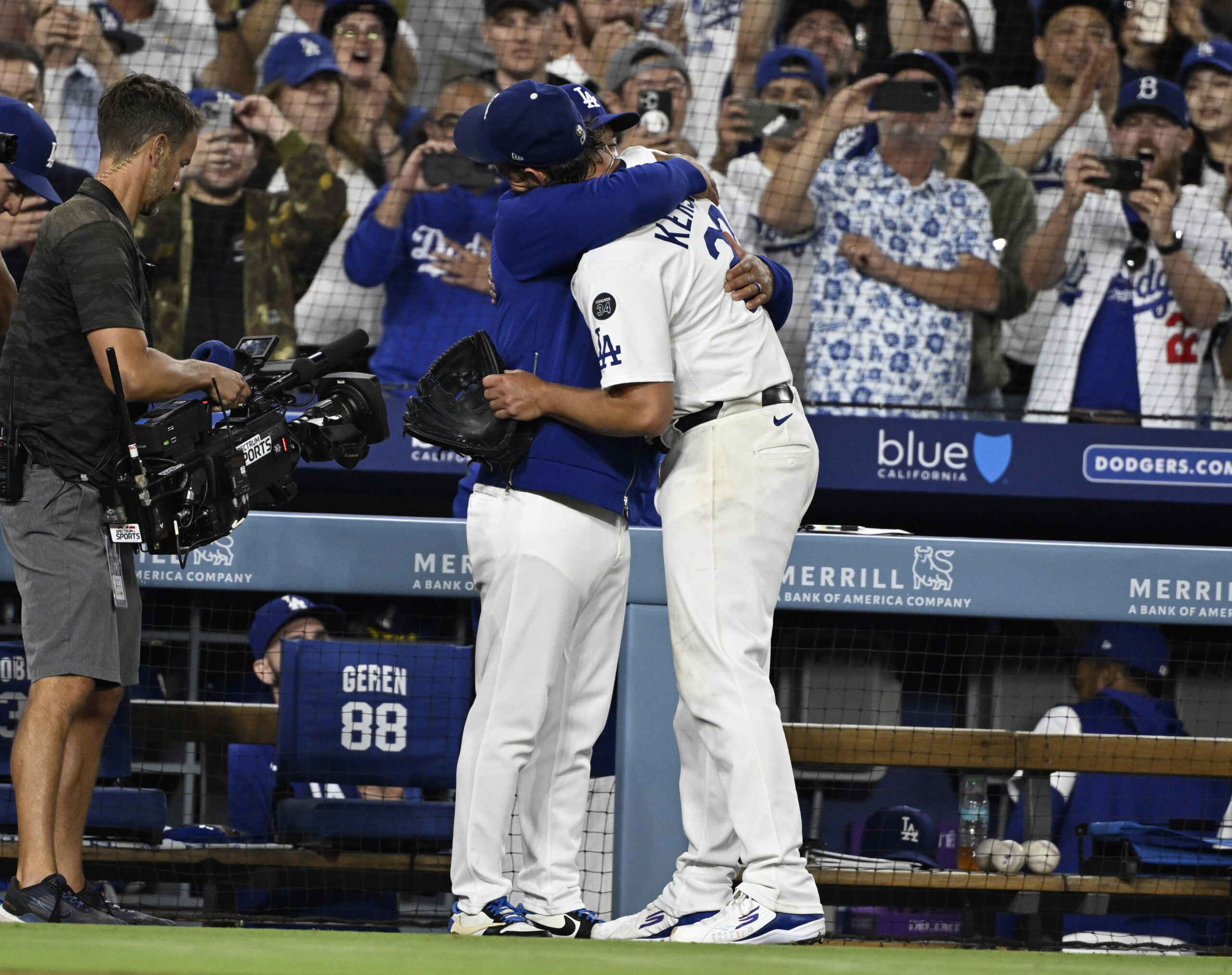 Dodgers starting pitcher Clayton Kershaw hugs Manager Dave Roberts after...