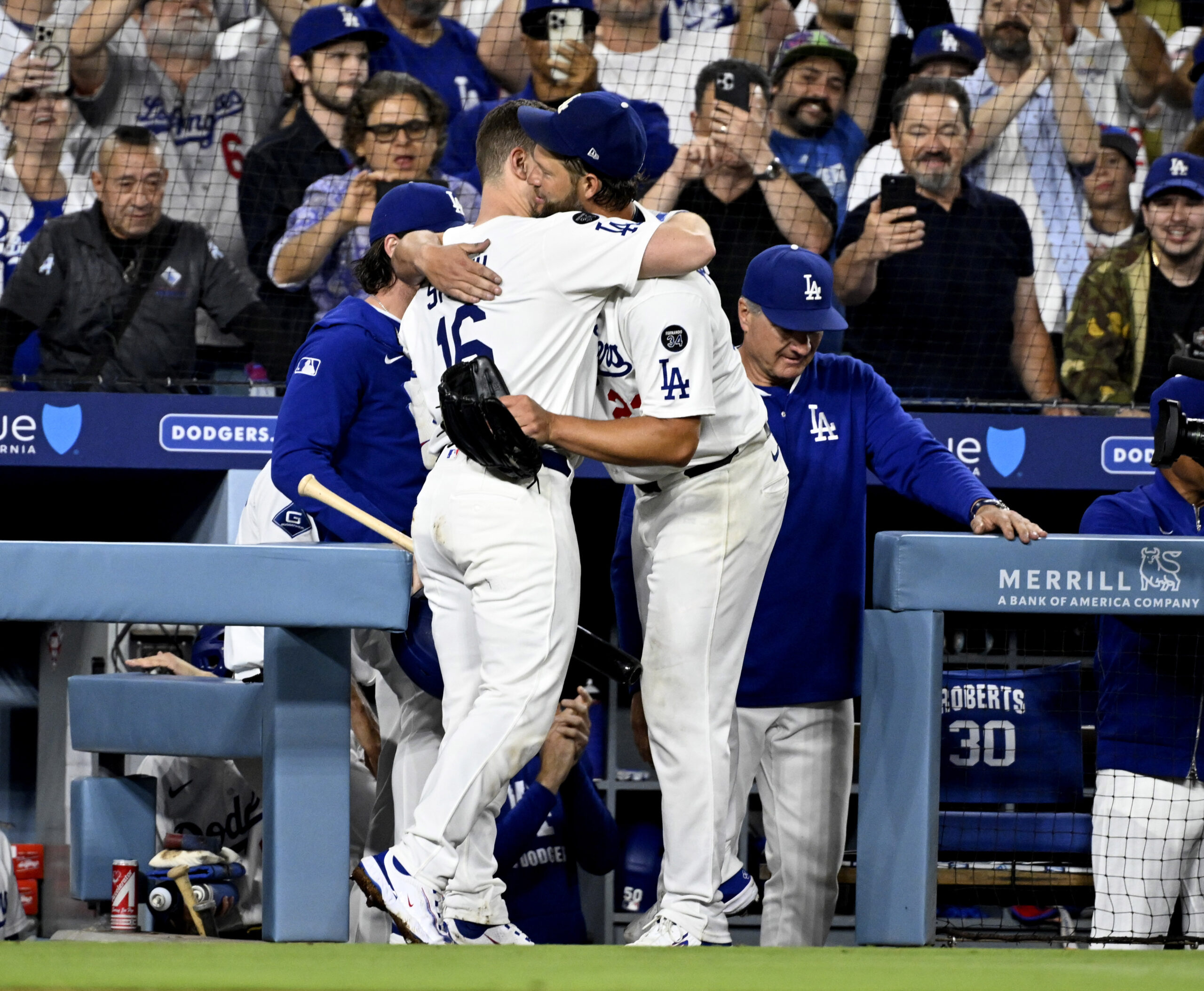 Dodgers starting pitcher Clayton Kershaw, right, hugs catcher Will Smith...