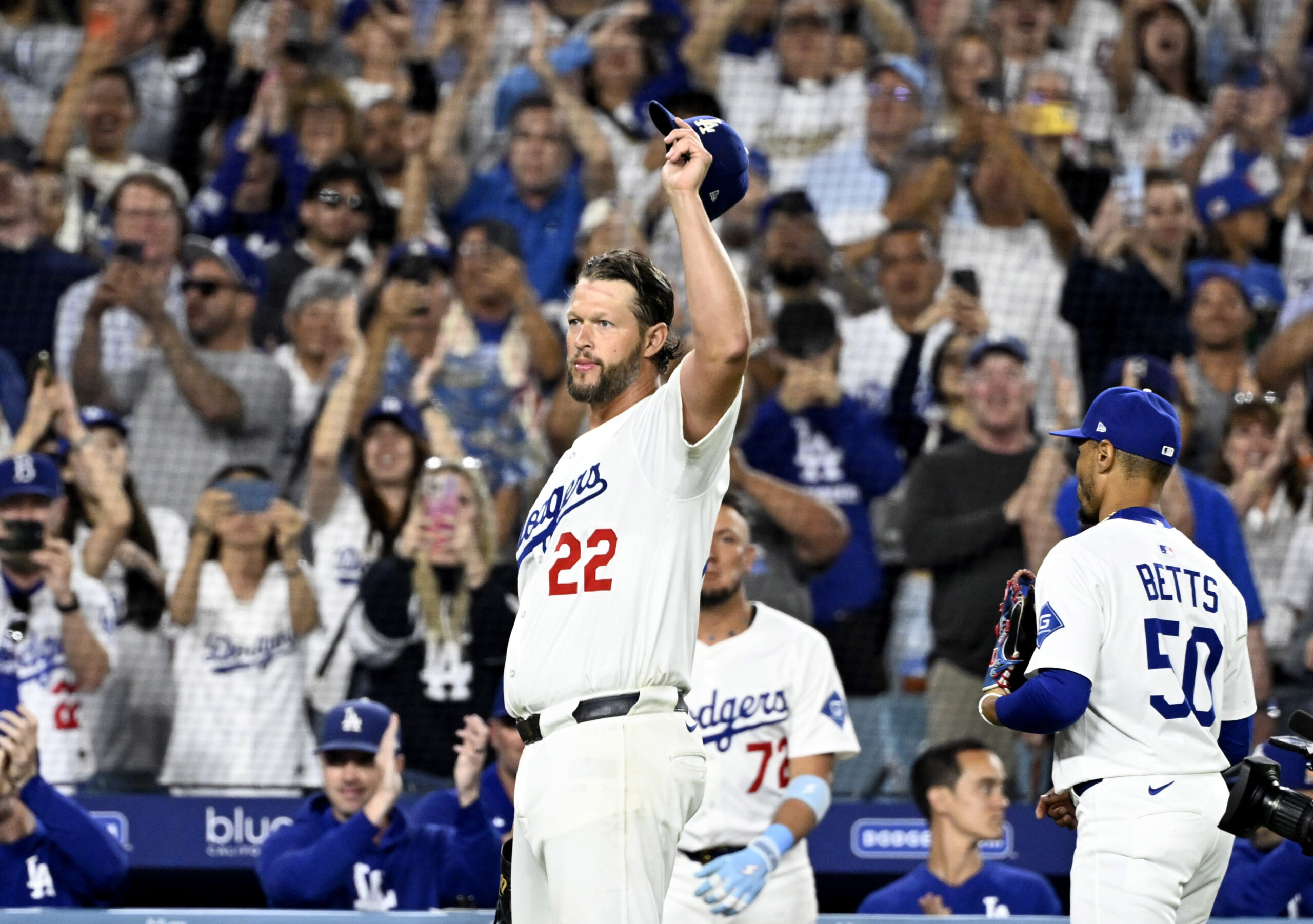 Dodgers starting pitcher Clayton Kershaw tips his cap to the...