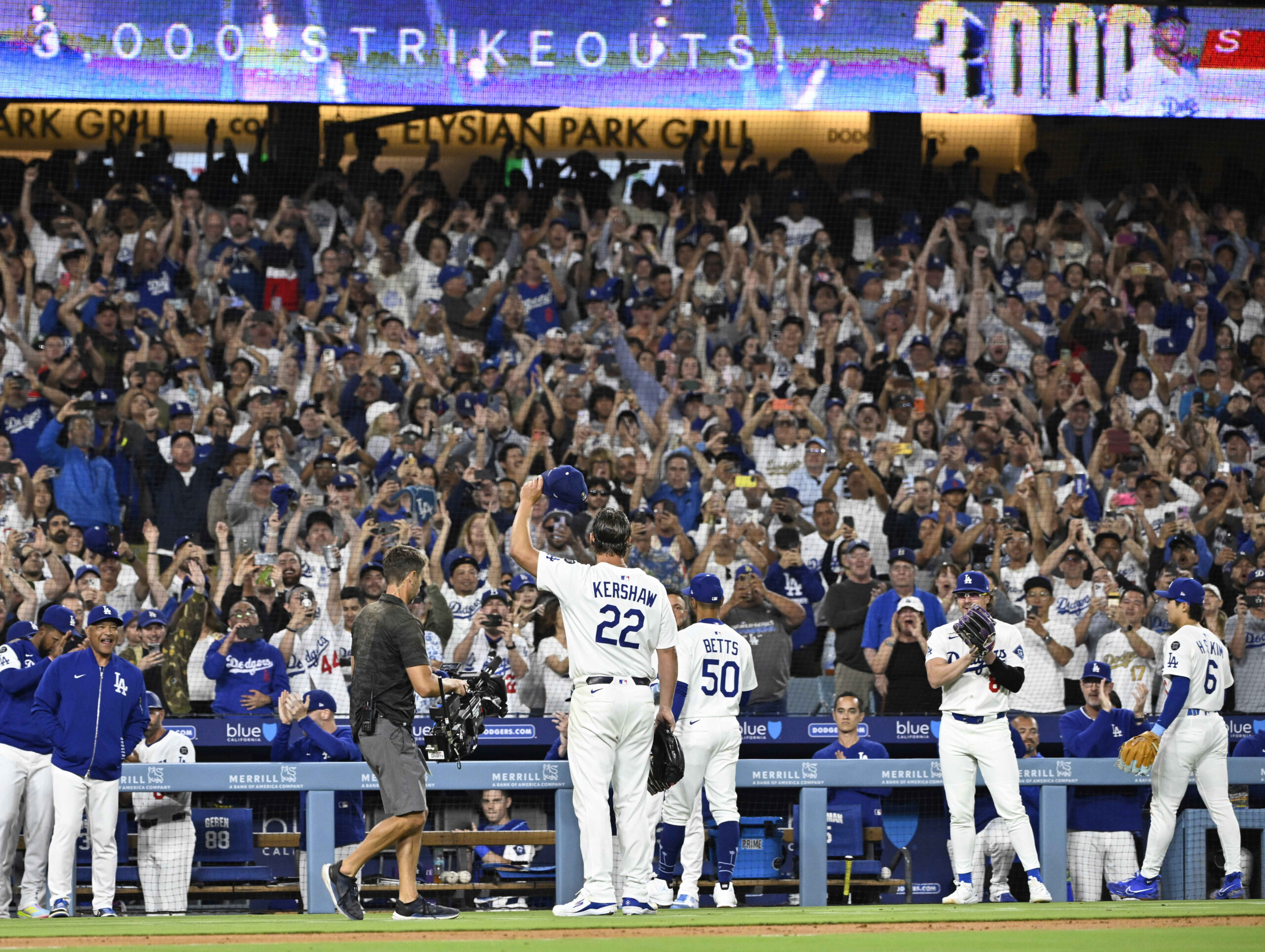 Dodgers starting pitcher Clayton Kershaw tips his cap to the...