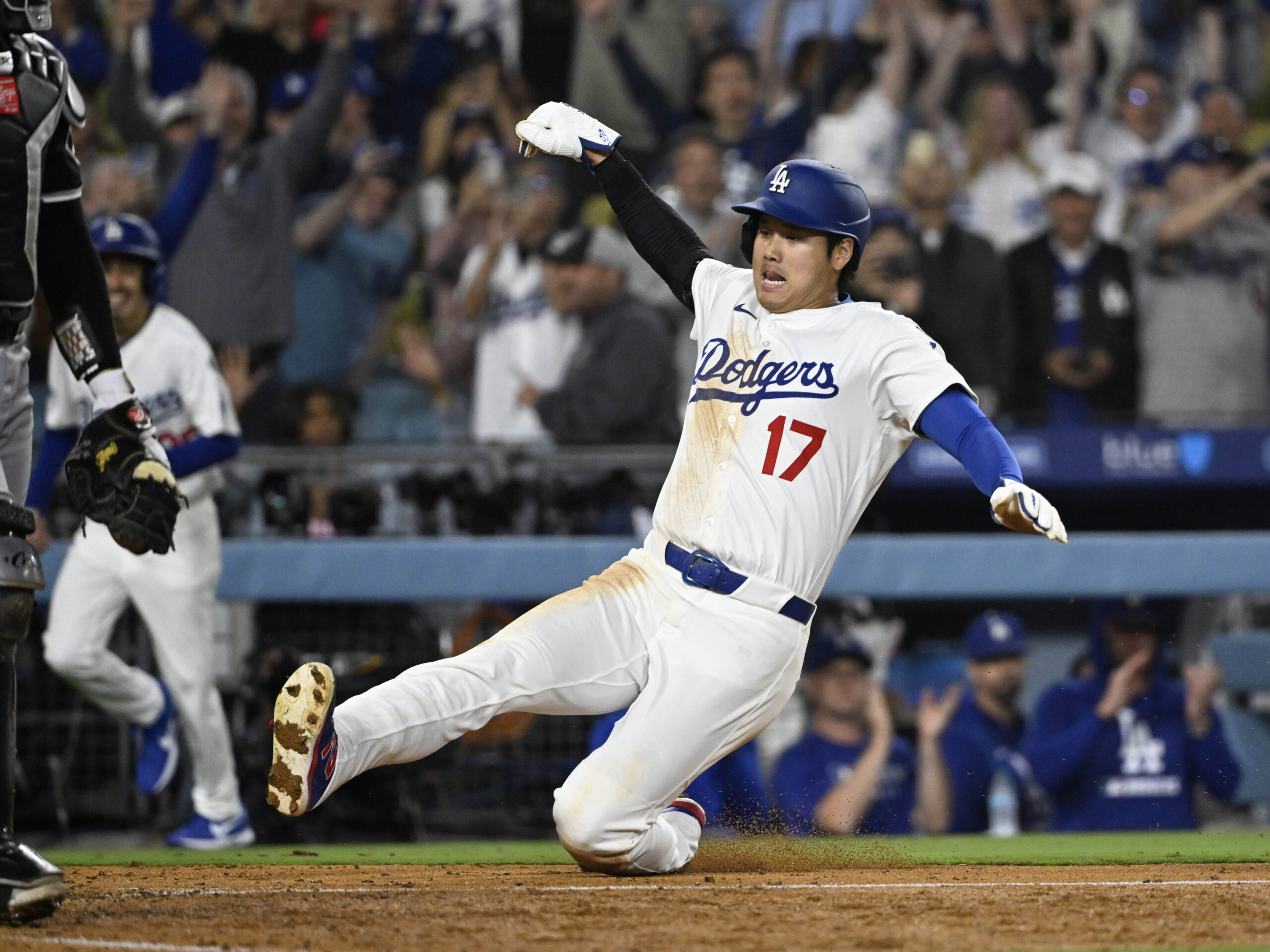 Shohei Ohtani #17 of the Los Angeles Dodgers scores the...