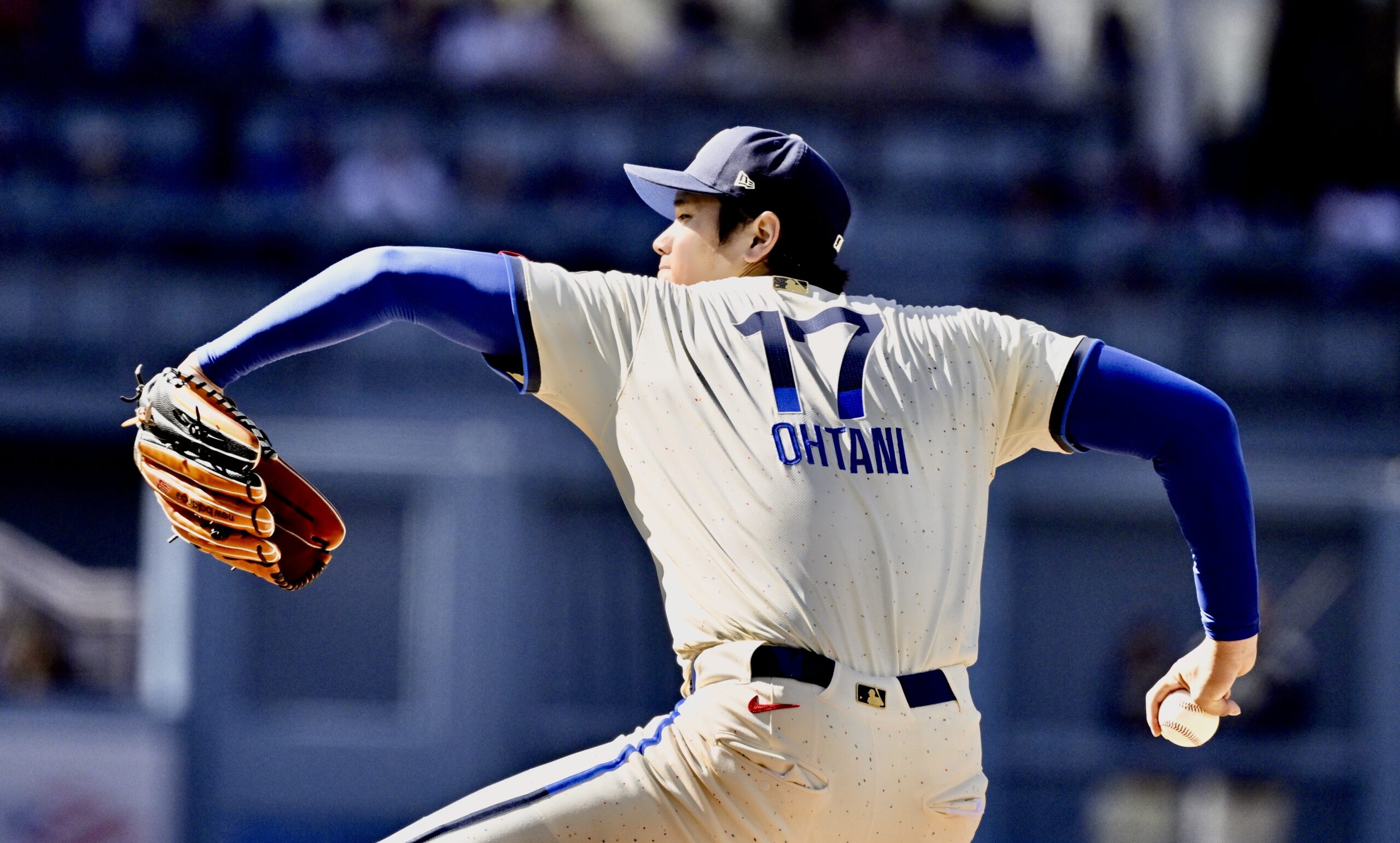 Starting pitcher Shohei Ohtani #17 of the Dodgers throws to...