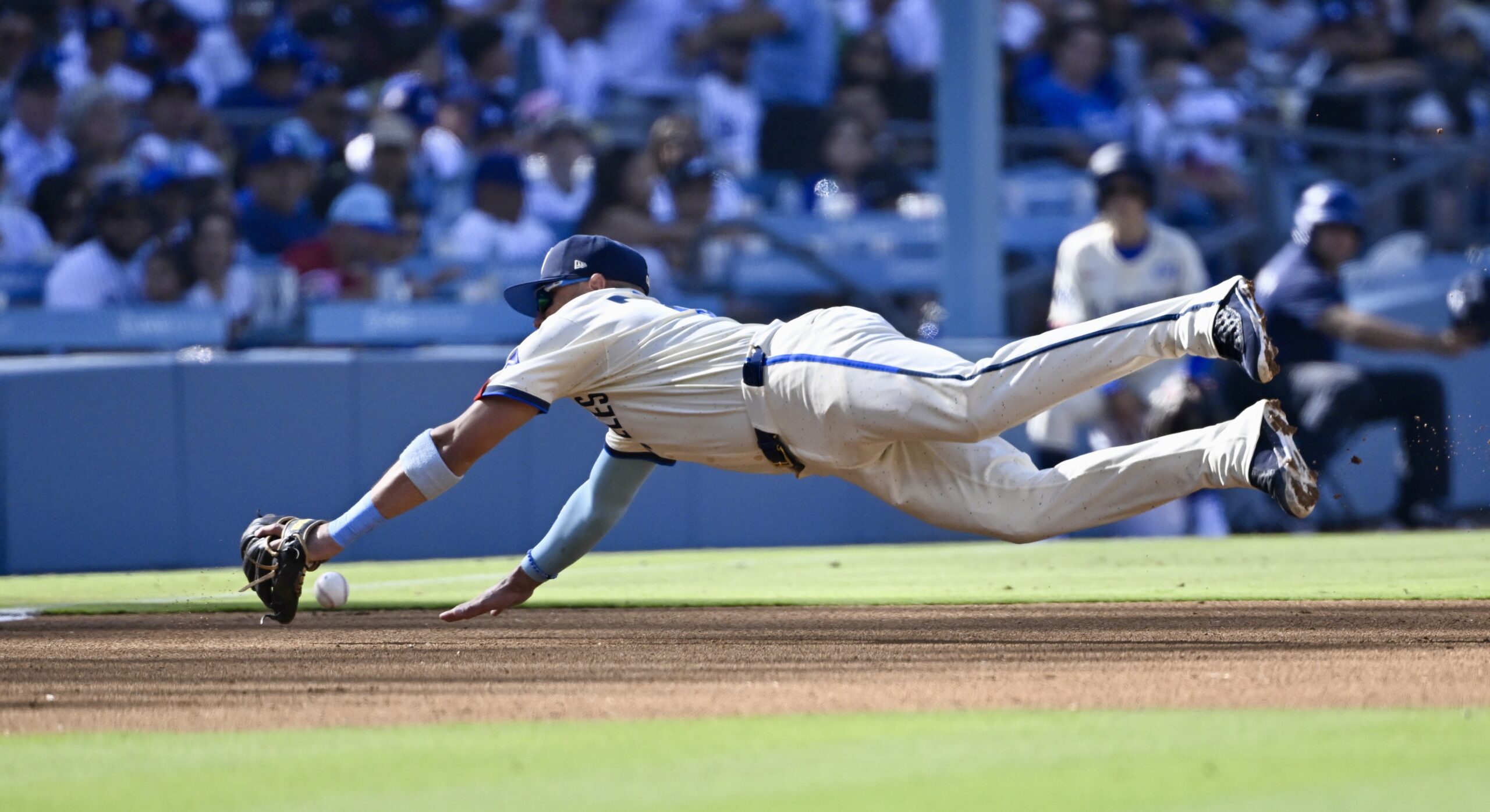 Third baseman’s Miguel Rojas #72 of the Dodgers can’t reach...