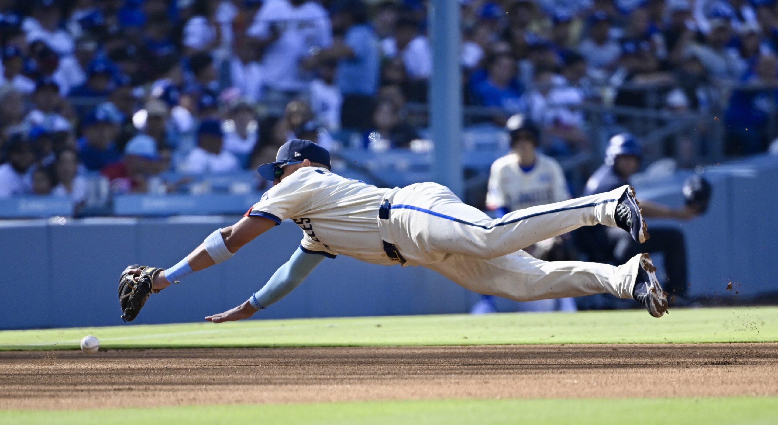 Third baseman’s Miguel Rojas #72 of the Dodgers can’t reach...