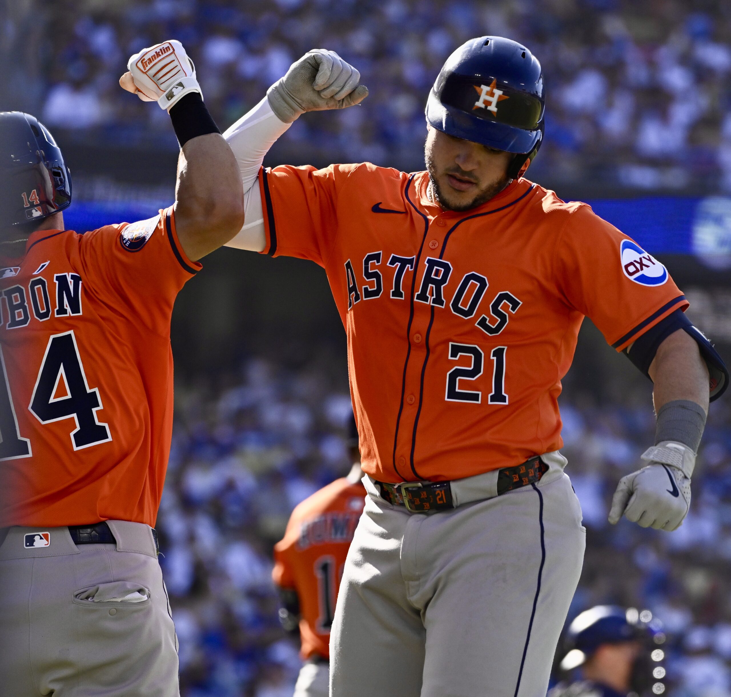 Yainer Diaz #21 of the Houston Astros high fives teammate...
